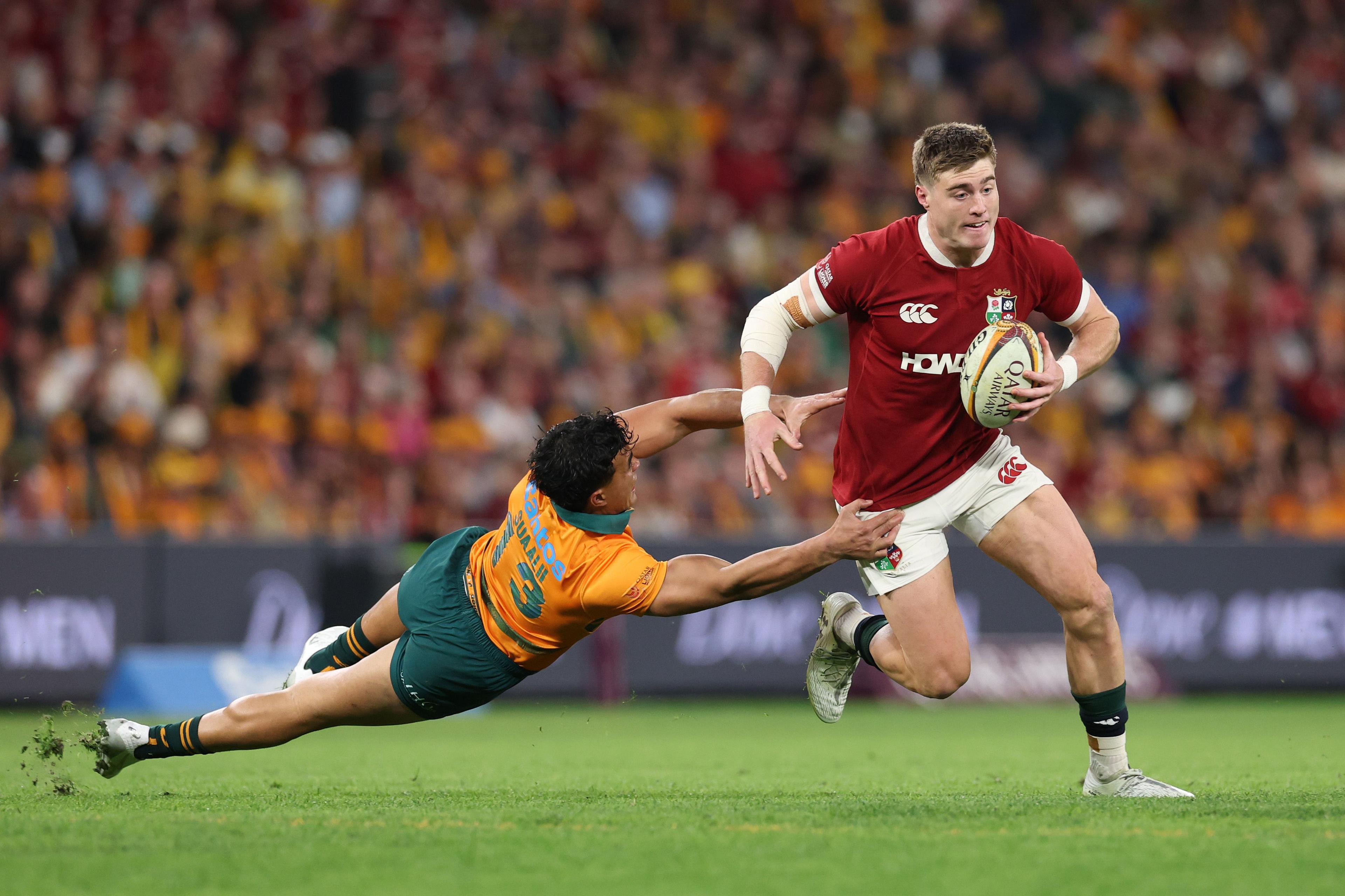 British and Irish Lions' Tommy Freeman gets past Australia's Joseph-Aukuso Suaalii during the 1st Test Match between Australia Wallabies and British & Irish Lions in Brisbane, Australia. Photo by David Rogers