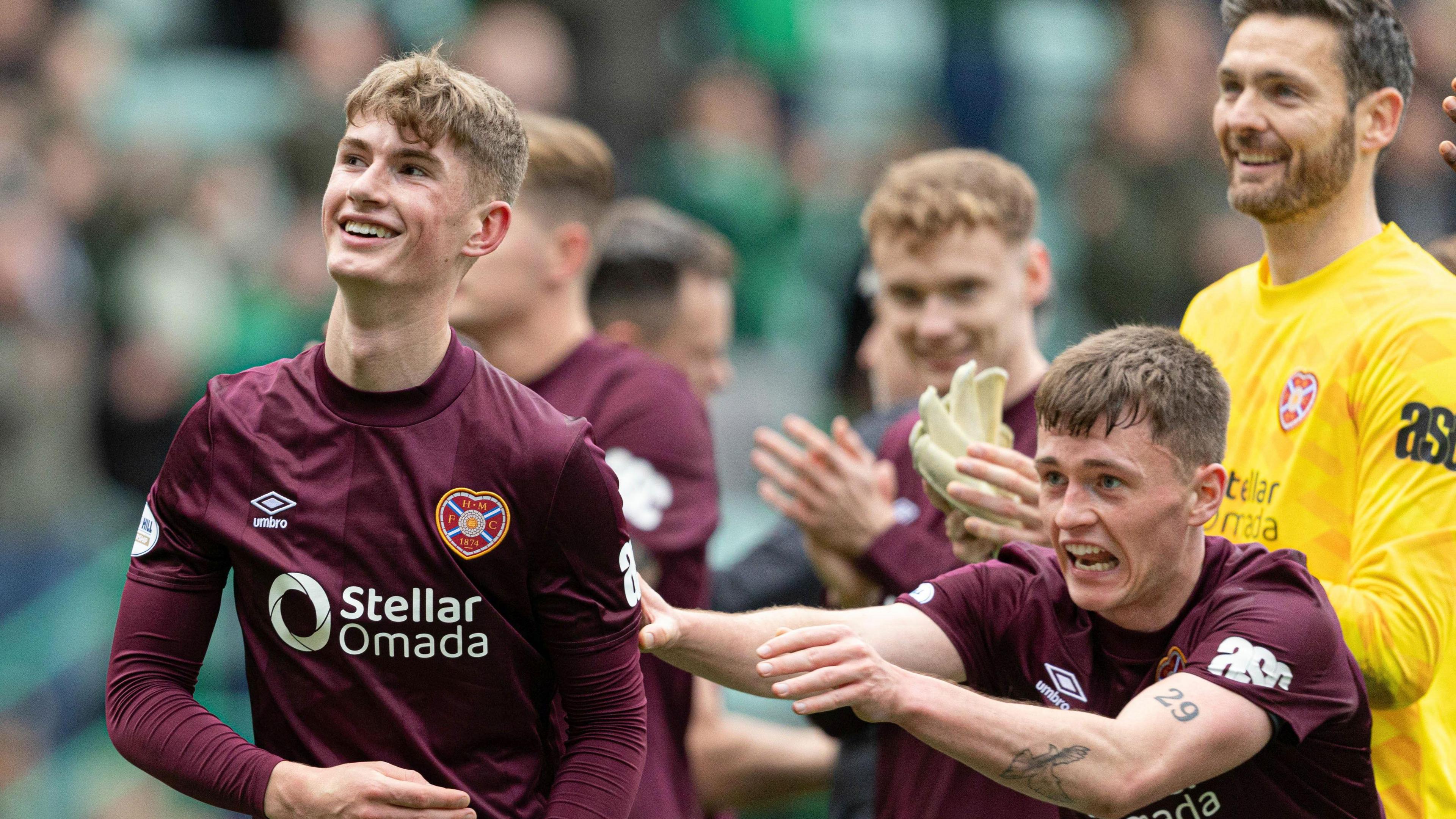 James Wilson (left) pushed to celebrate with Hearts fans by James Penrice at Easter Road