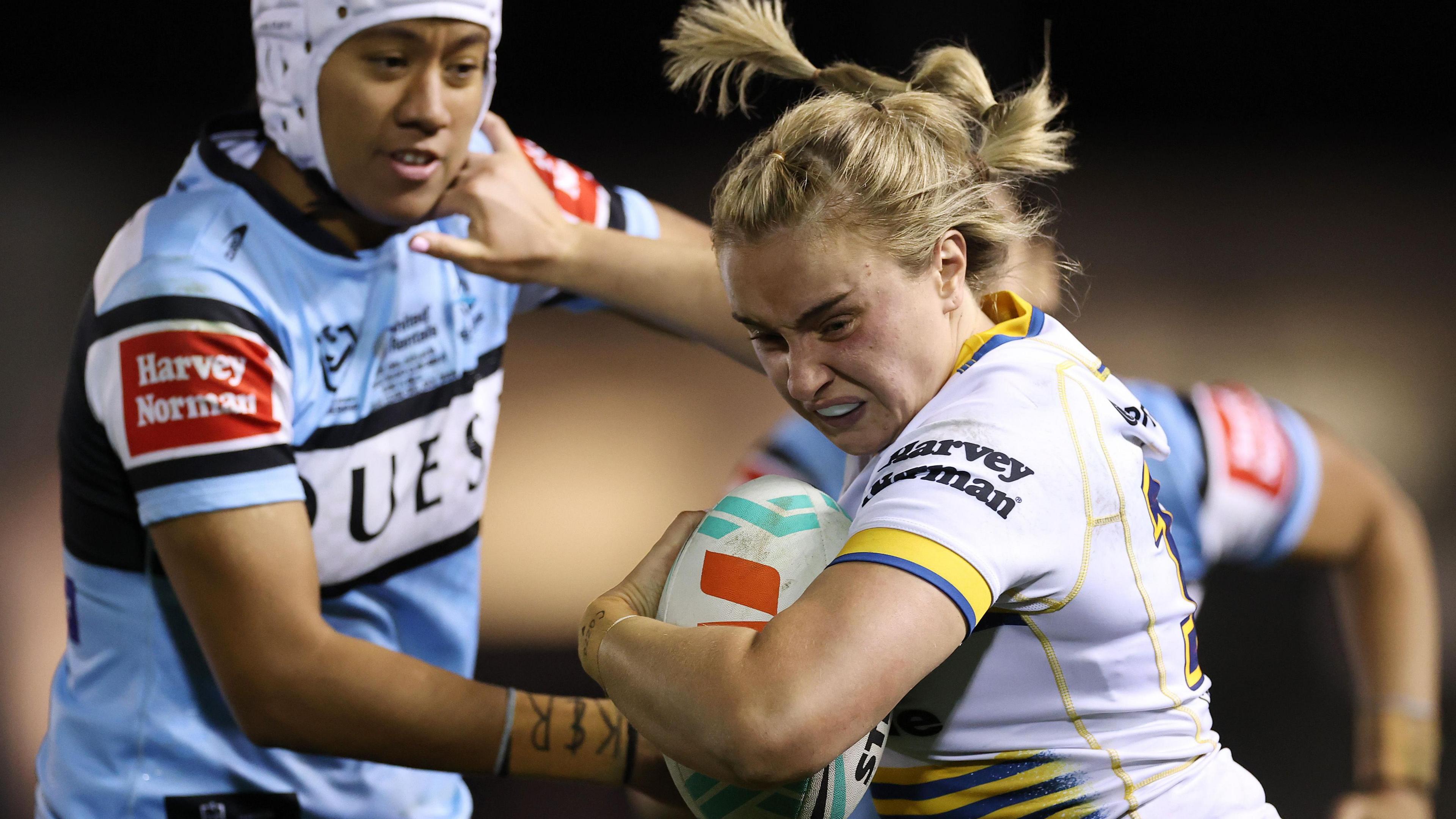 Paige Travis fends away Chantelle Kiria-Ratu while playing for Parramatta against Cronulla
