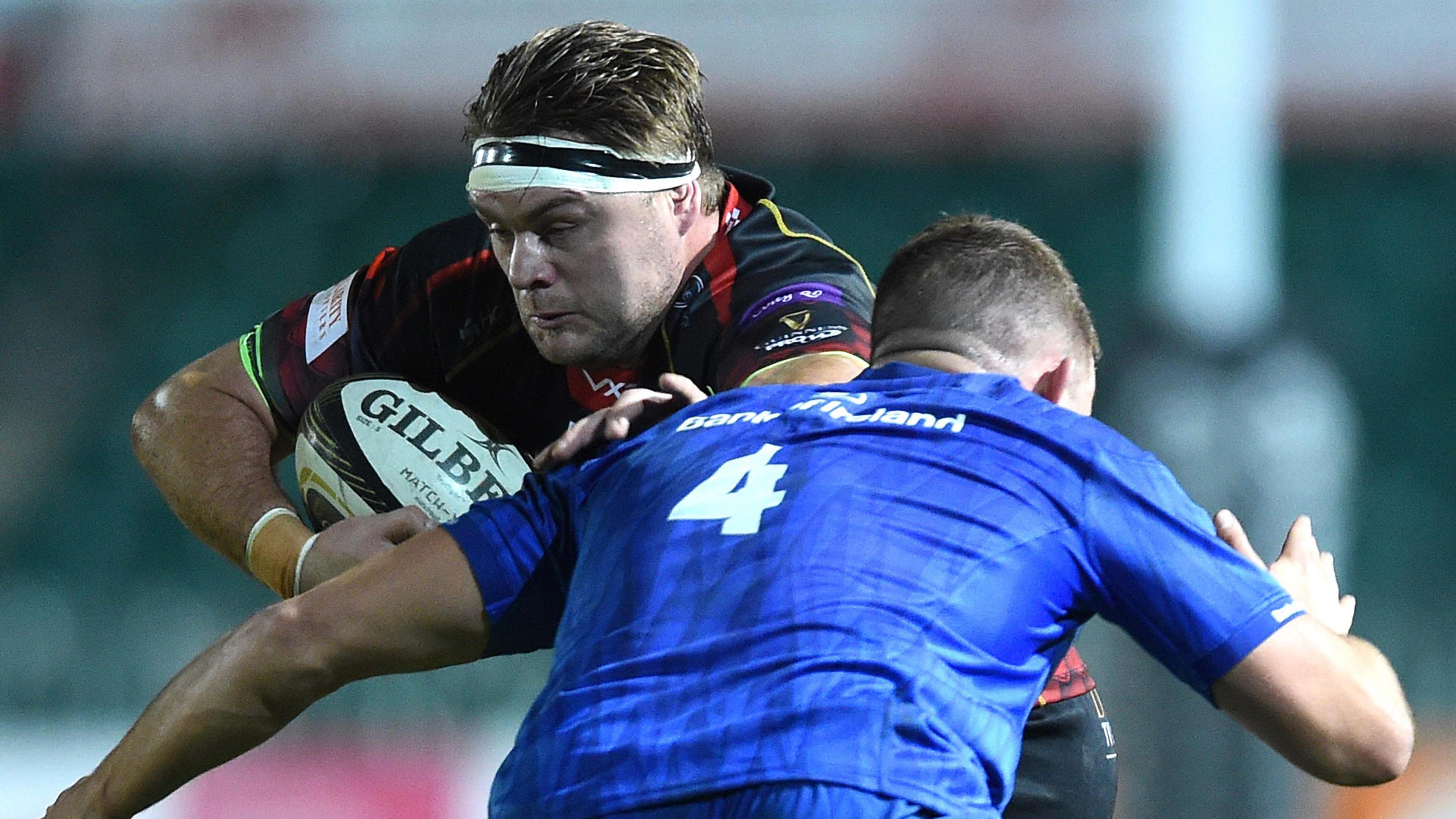 Lewis Evans being tackled by a Leinster defender while playing for the Dragons