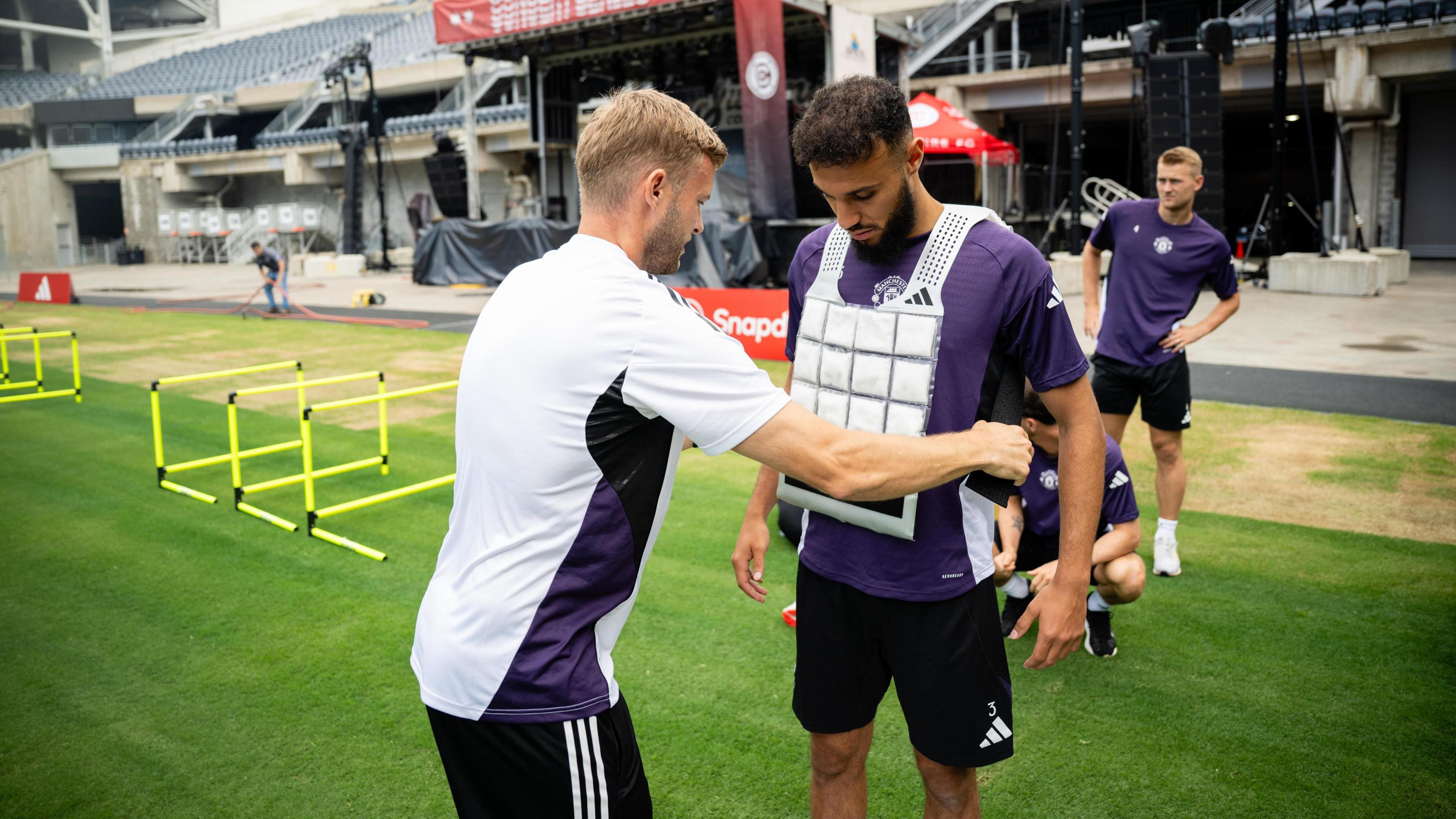 Manchester United's Noussair Mazraoui getting a cooling jacket put on in training during the Premier League Summer Series