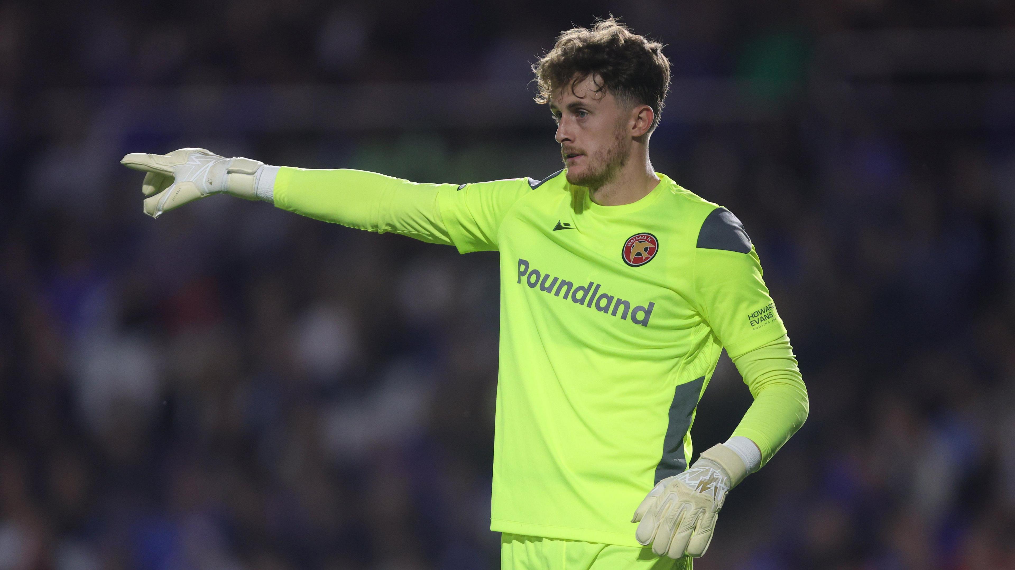 Walsall goalkeeper Sam Hornby points at his defence during a game