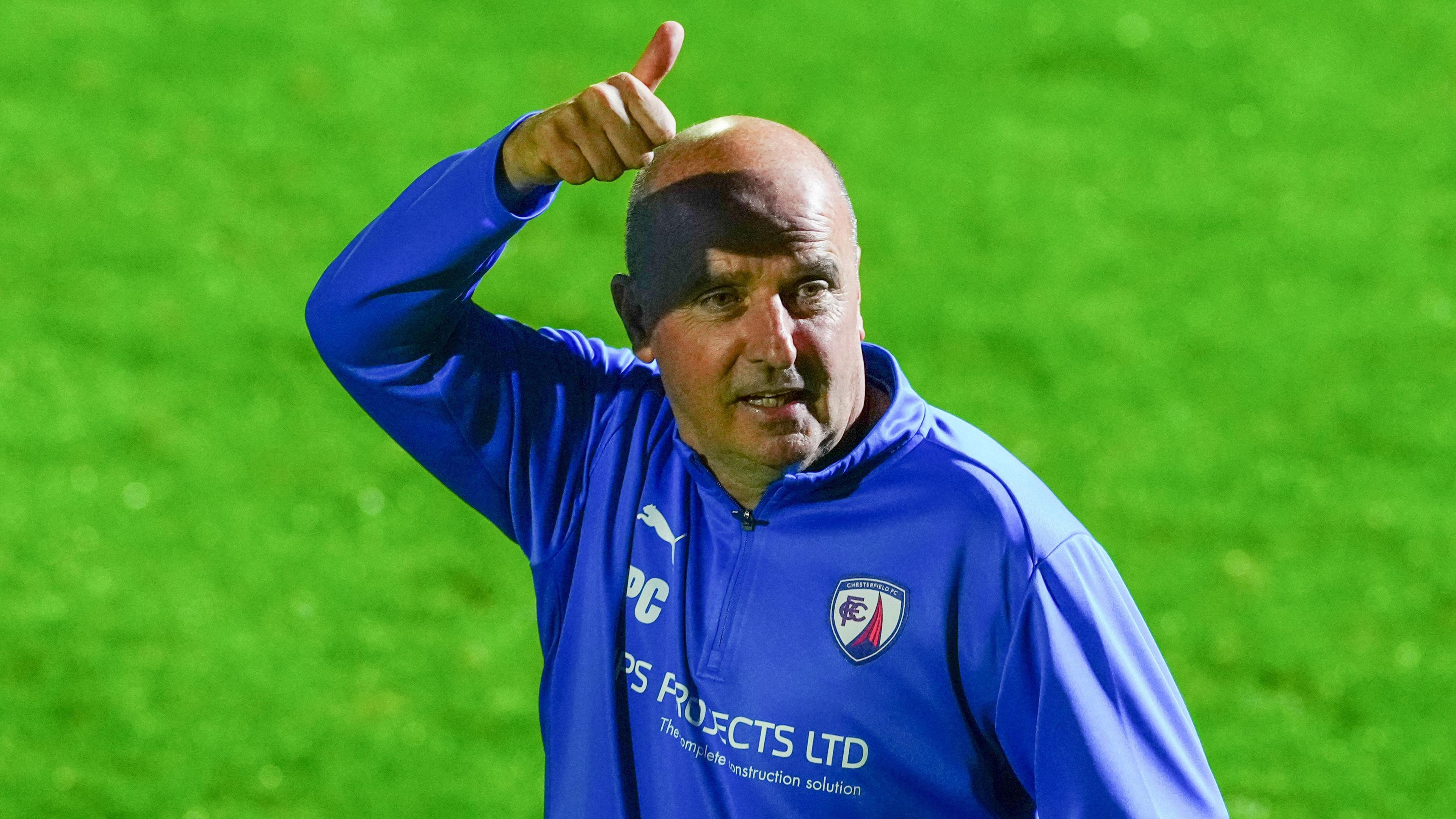 Chesterfield manager Paul Cook gives the thumbs-up to supporters