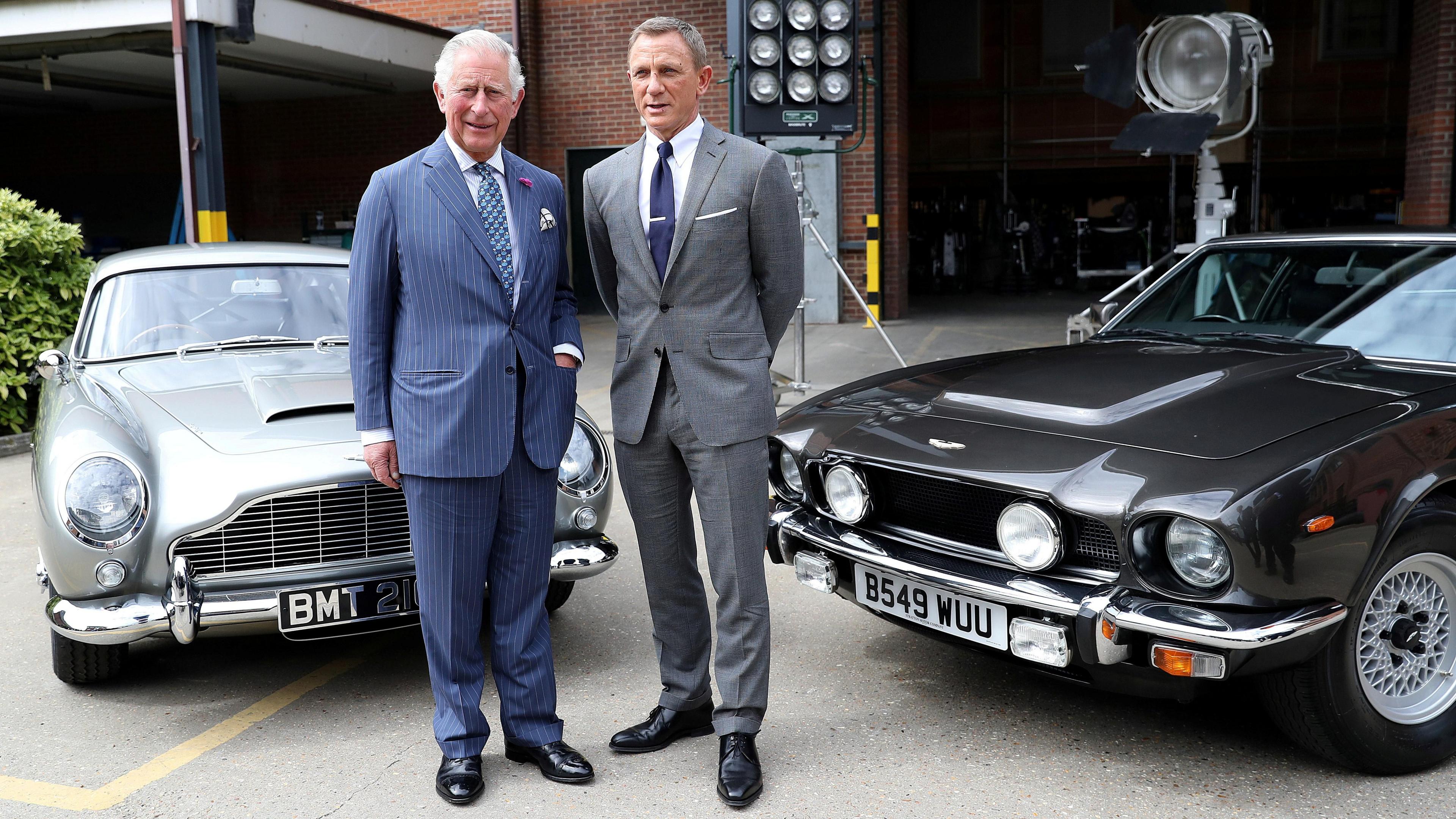 King Charles, then Prince, poses with British actor Daniel Craig as he tours the set of the 25th James Bond Film at Pinewood Studios in Iver Heath, Buckinghamshire