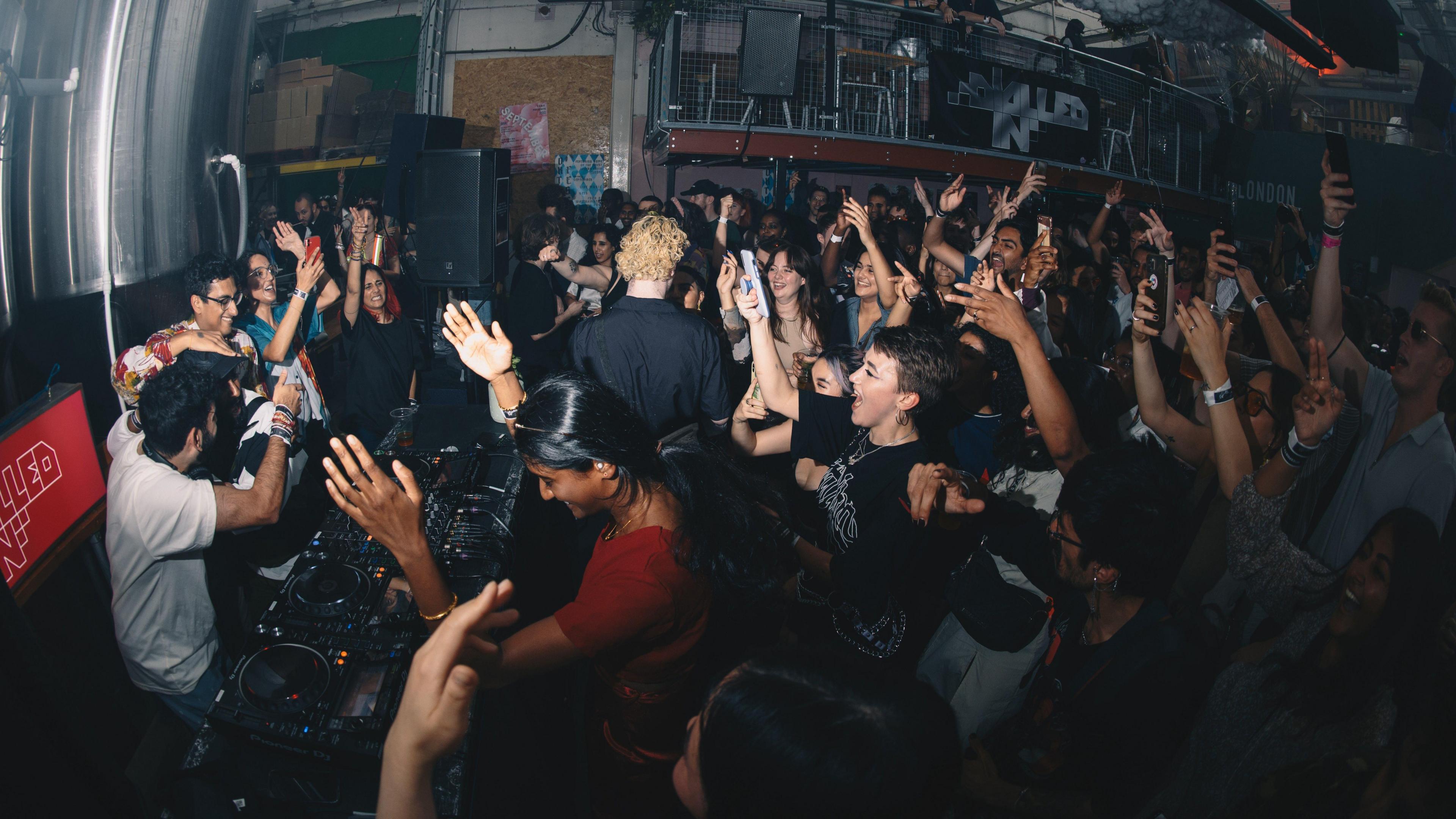 Dialled-in event which is like a club night, with a crowd dancing around the DJ.