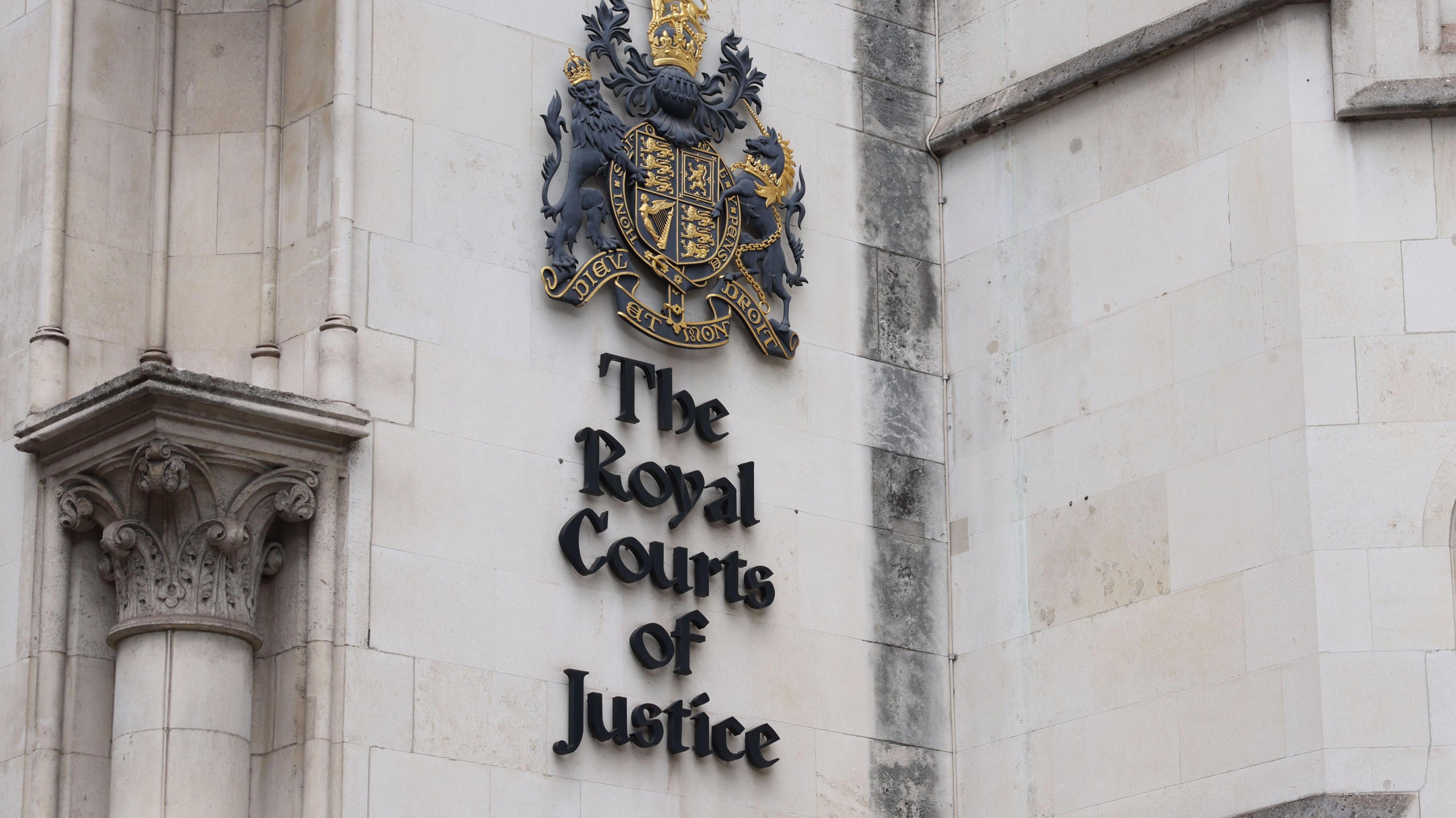Royal Courts of Justice sign on the gothic building in London.