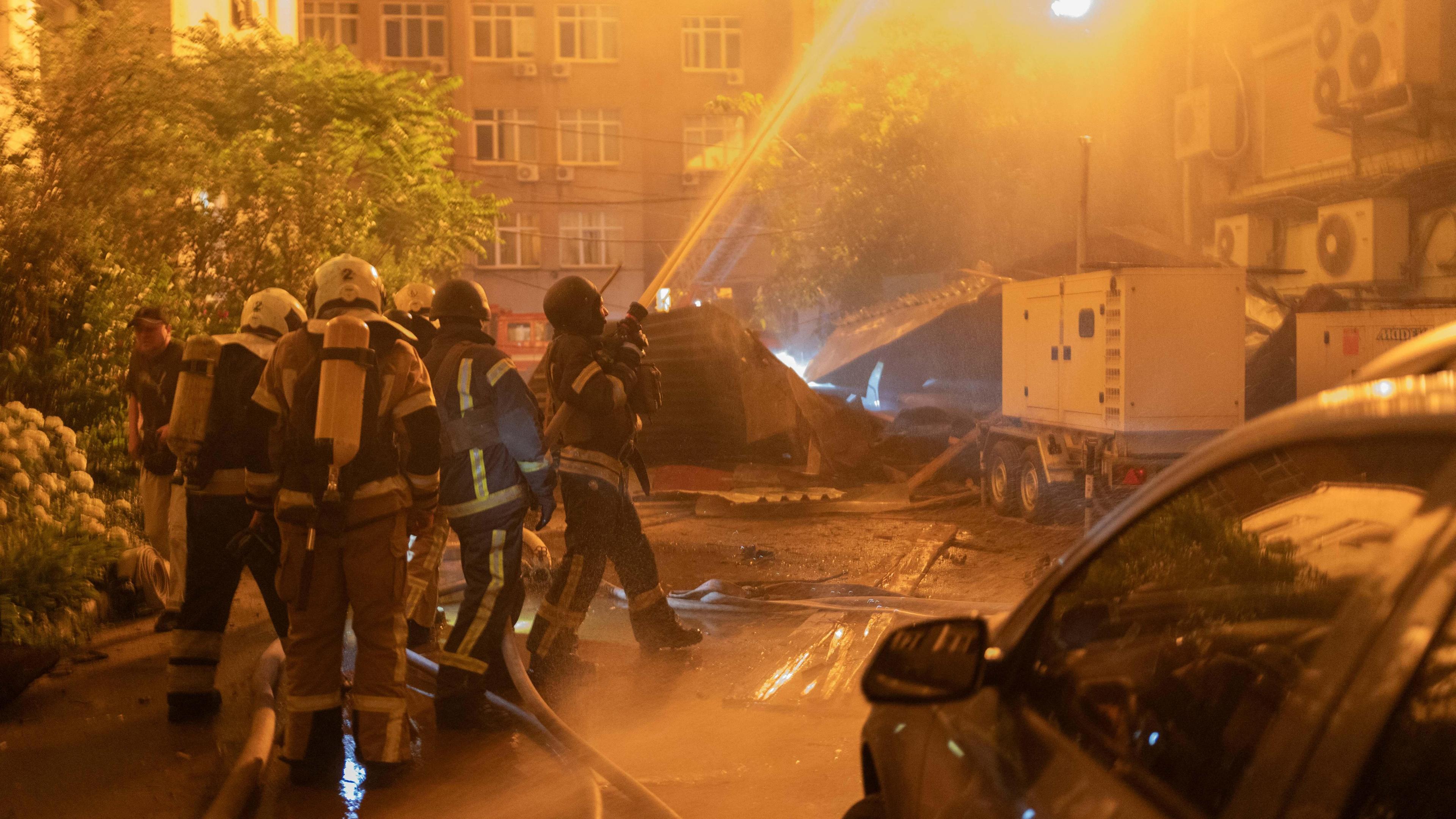 Firefighters douse flames in Kyiv.