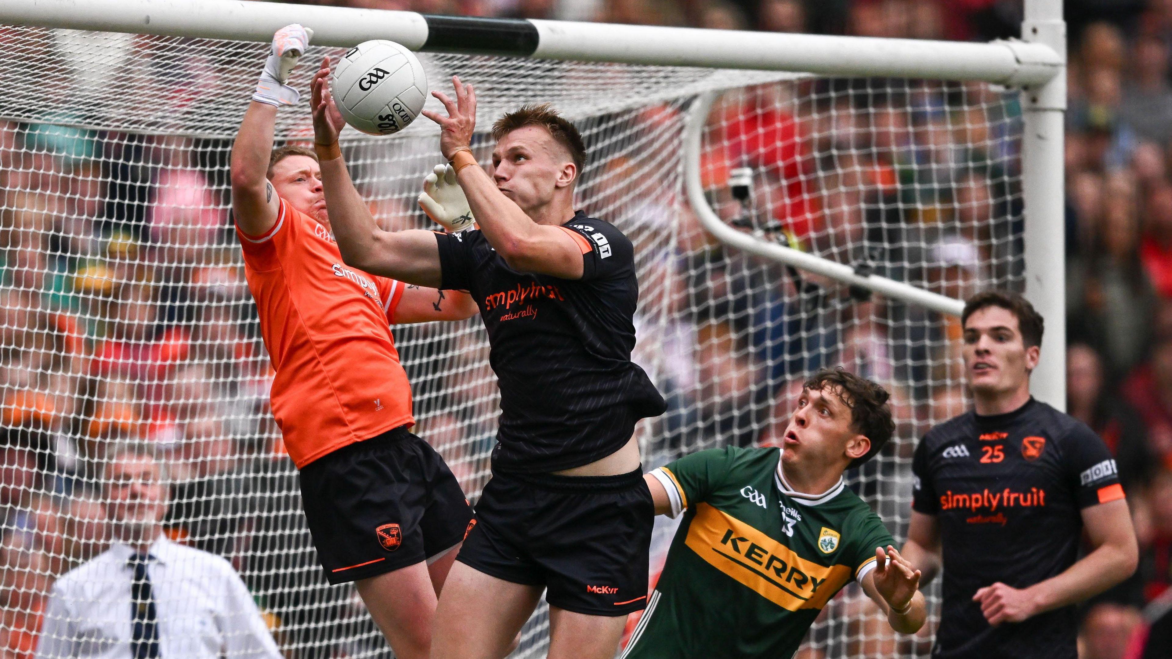 Rian O'Neill soars in front of his Armagh keeper Blaine Hughes to catch the ball on his own goal-line in the final play of the All-Ireland Semi-Final as David Clifford and Jarly Og Burns look on 