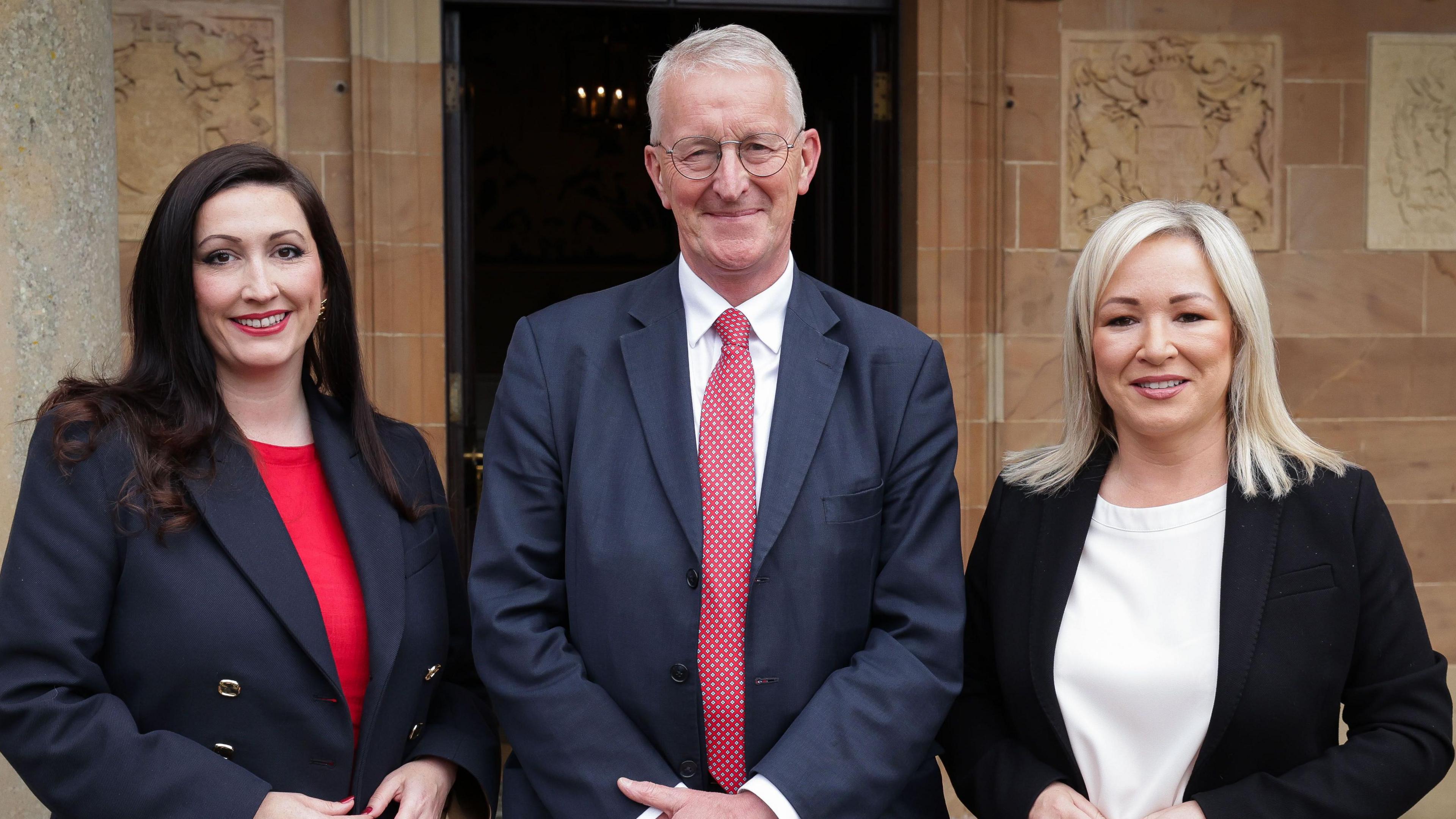 Hilary Benn pictured standing between the First Minister Michelle O’Neill and deputy First Minister Emma Little-Pengelly.