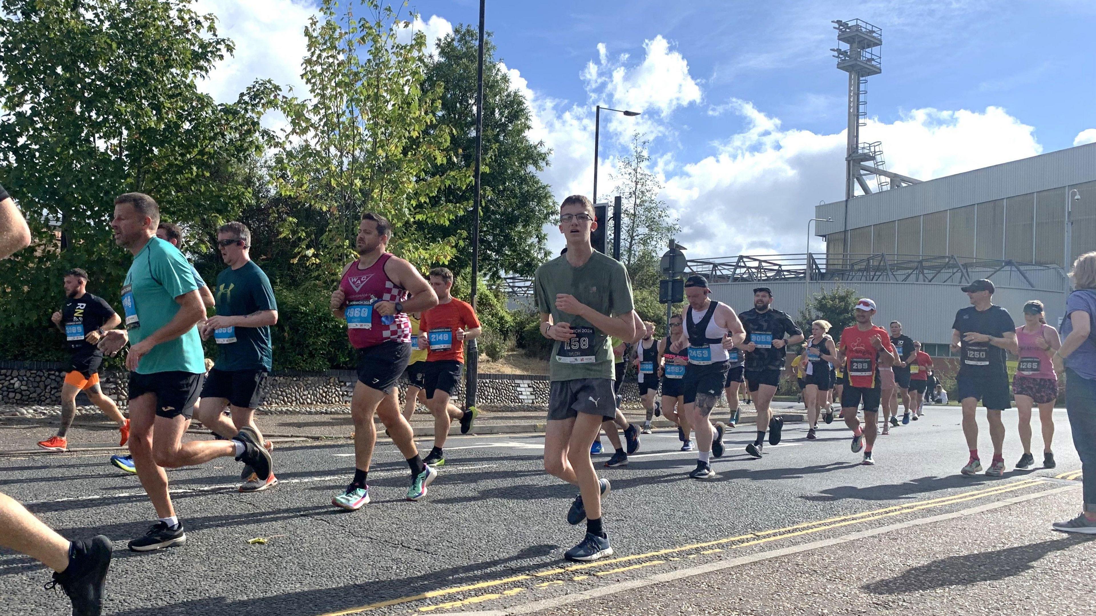 Runners passing Carrow Road, the home ground of Norwich City Football Club