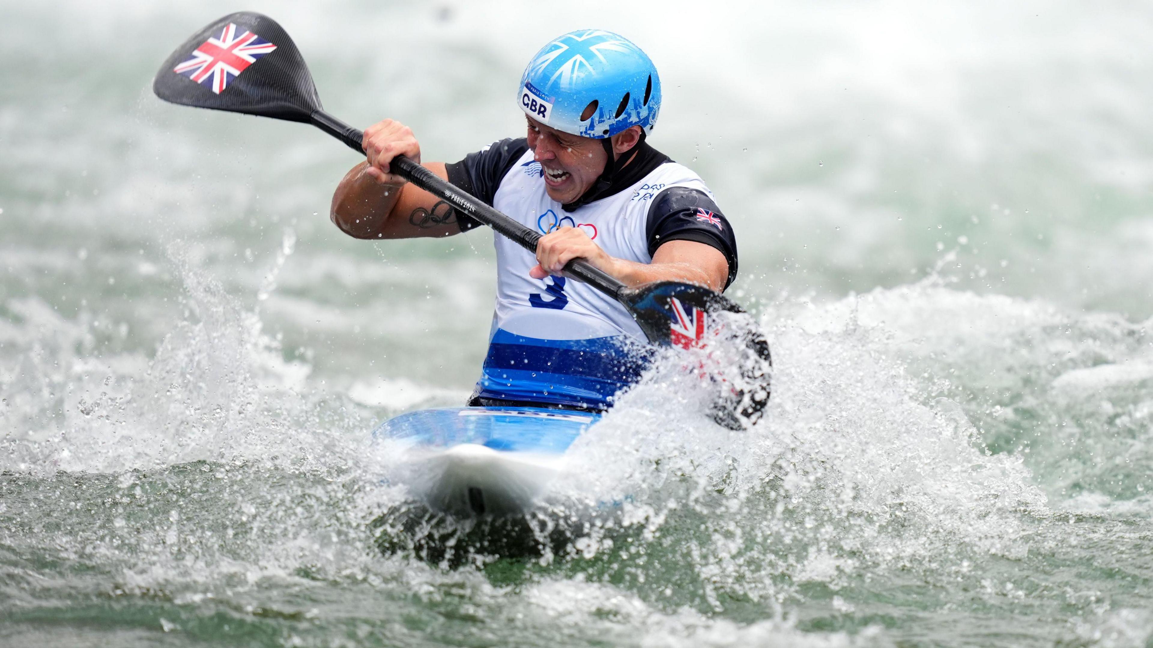 Joe Clarke paddling in his kayak during the men's kayak cross final