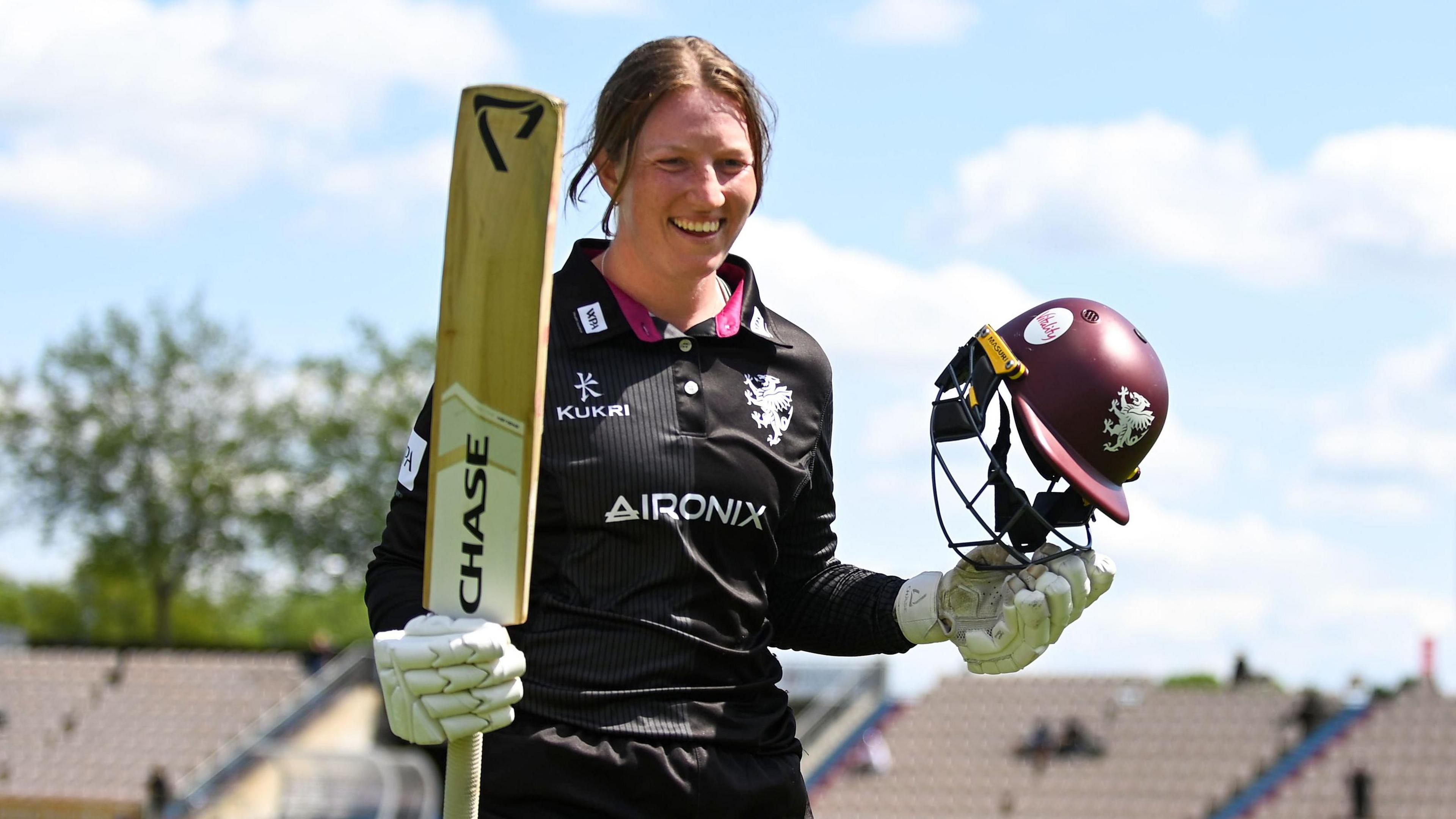 Somerset's Bex Odgers waves her bat after scoring an unbeaten century against Hampshire