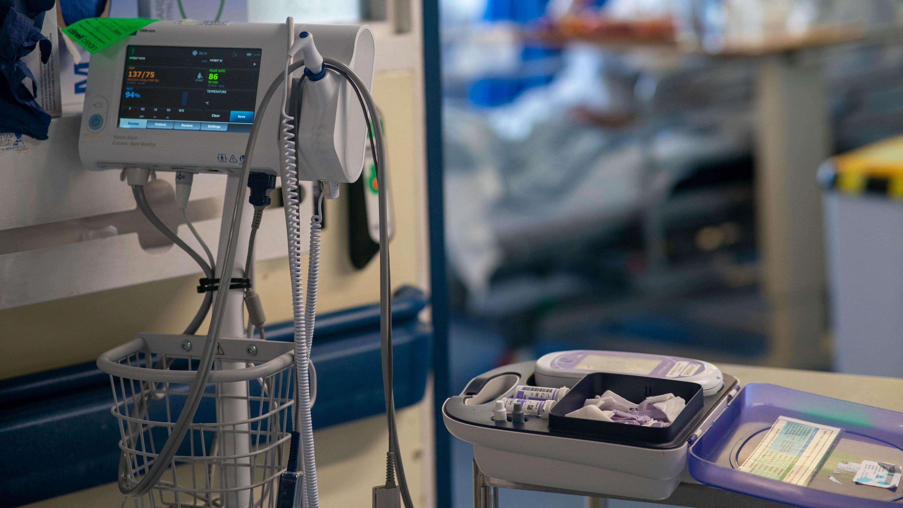 General view of medical equipment in front of a hospital bed on a NHS ward