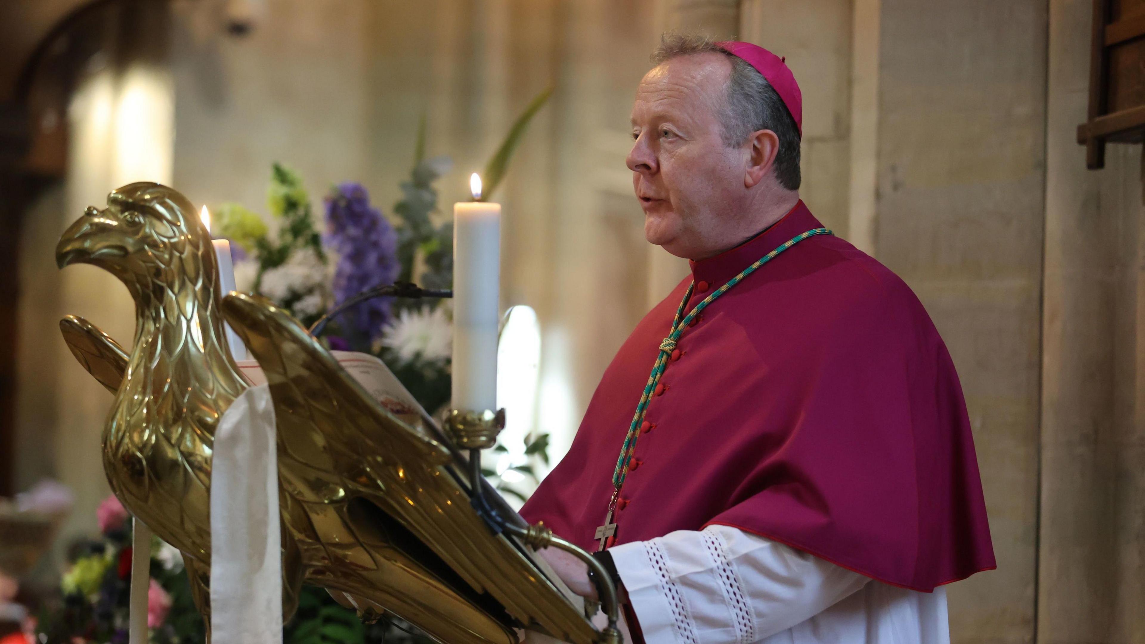 Archbishop Eamon Martin standing on the alter of a church. 