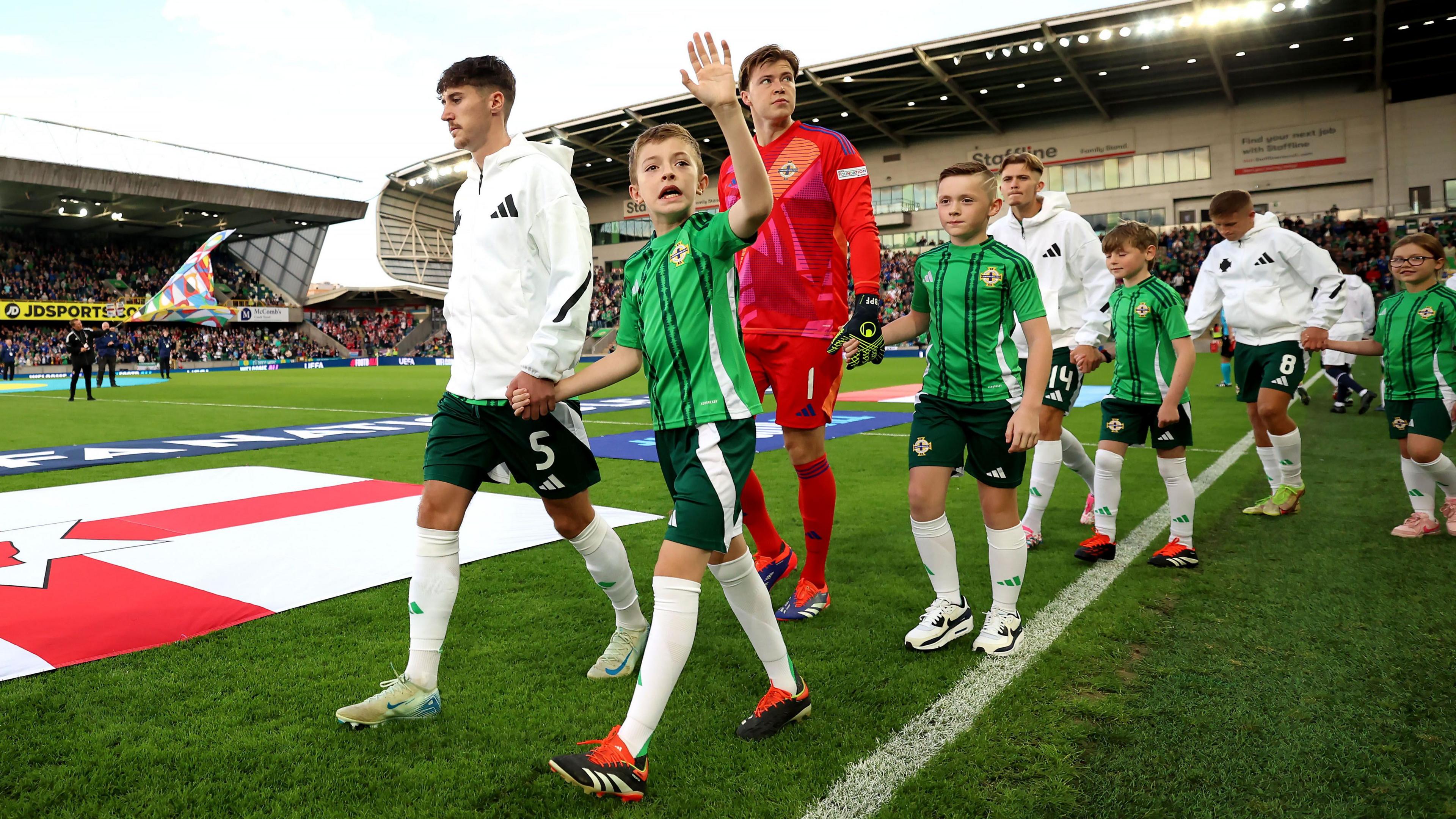 Trai Hume leads out Northern Ireland