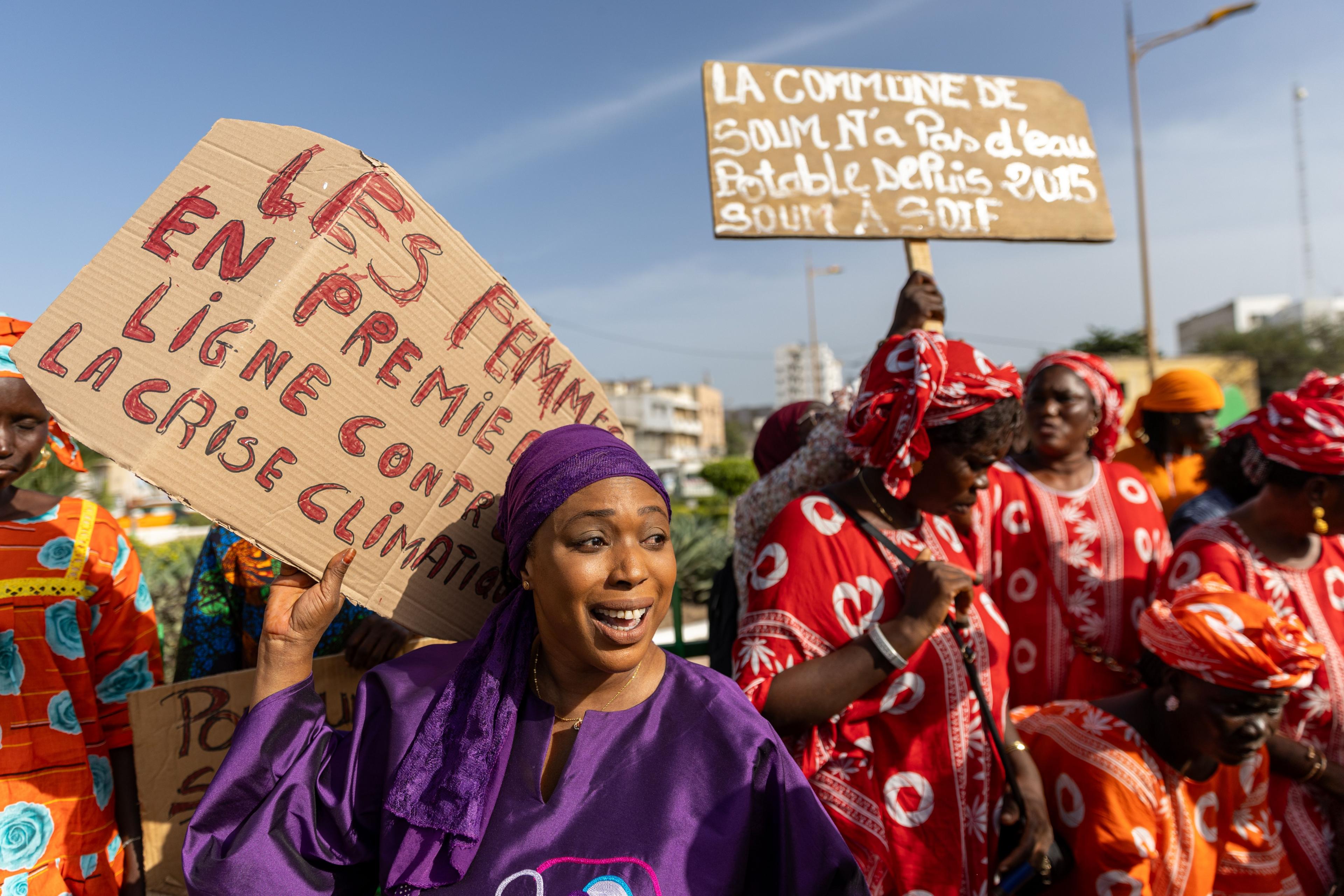 Climate activist and organiser of the 4th Women's March for Climate, Khady Camara (L), dressed in purple addresses participants in Dakar, Senegal - Saturday 2 November 2024