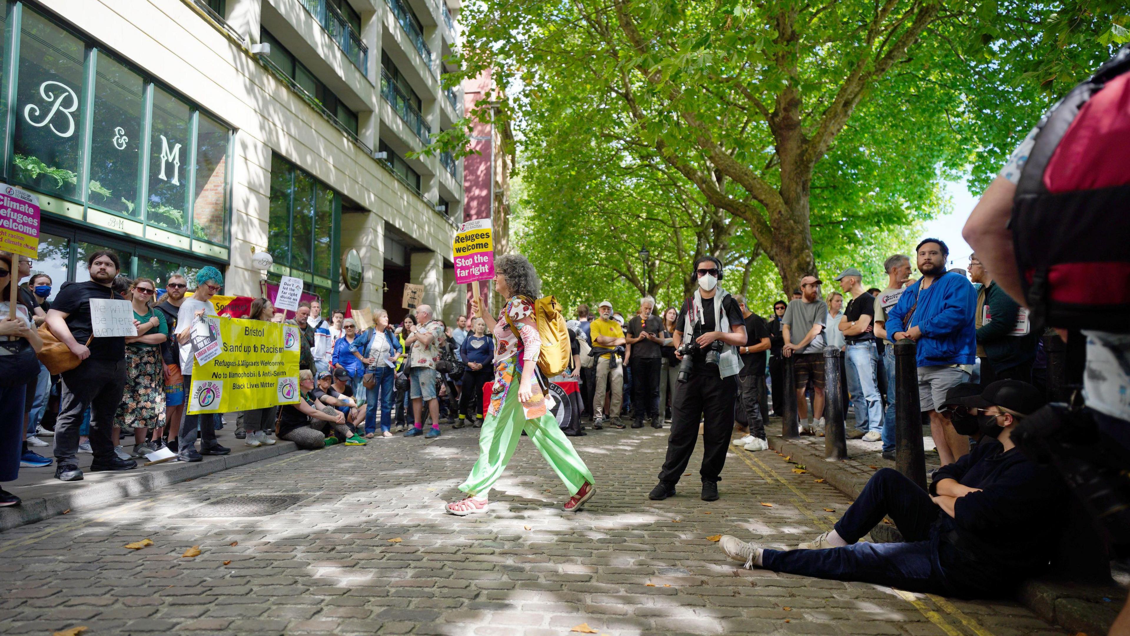 Protesters carrying pro-immigration and anti-racism placards surrounding the hotel in Bristol.