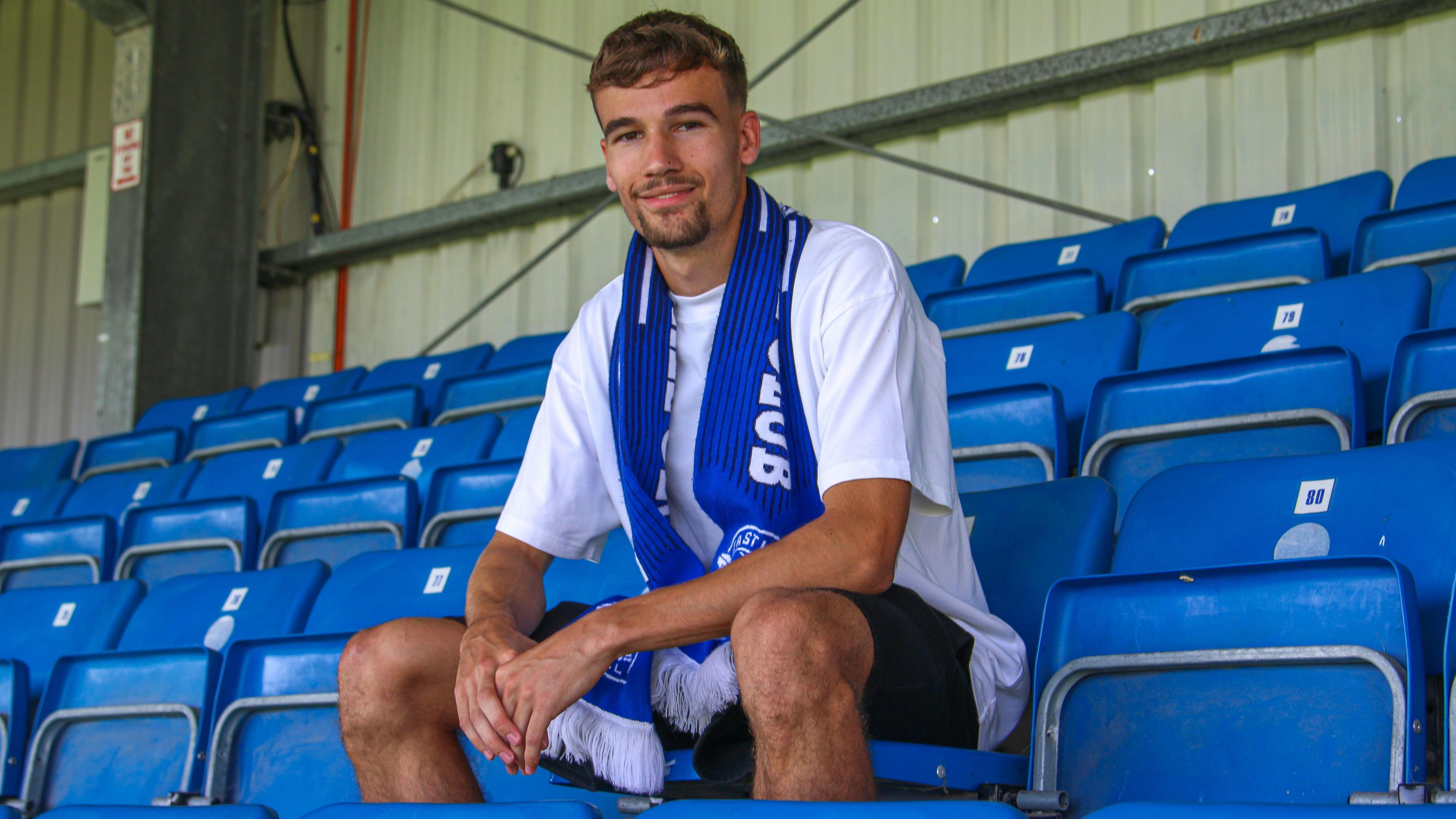 Reece Johnson poses for a photo after signing for Eastleigh on loan