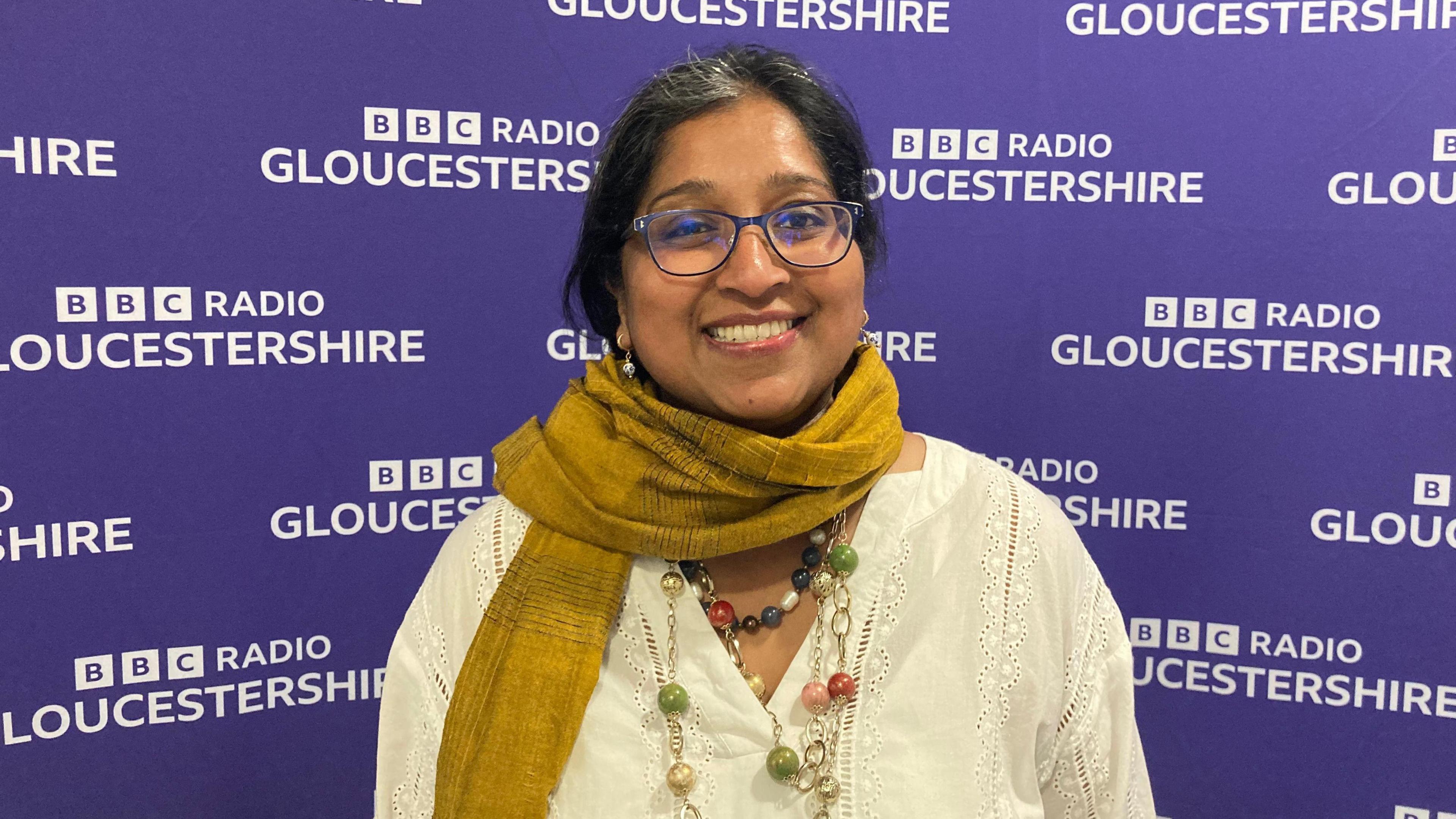 Marina Moore stood against the BBC Radio Gloucestershire backdrop