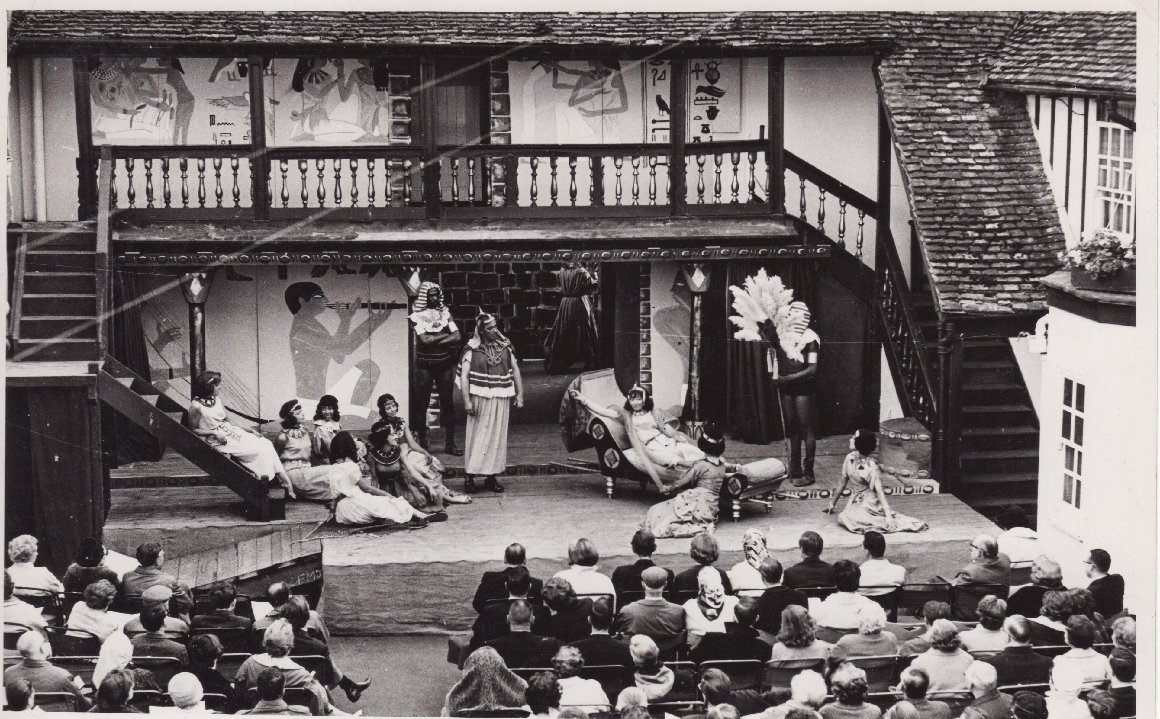 Black and white image of actors on stage