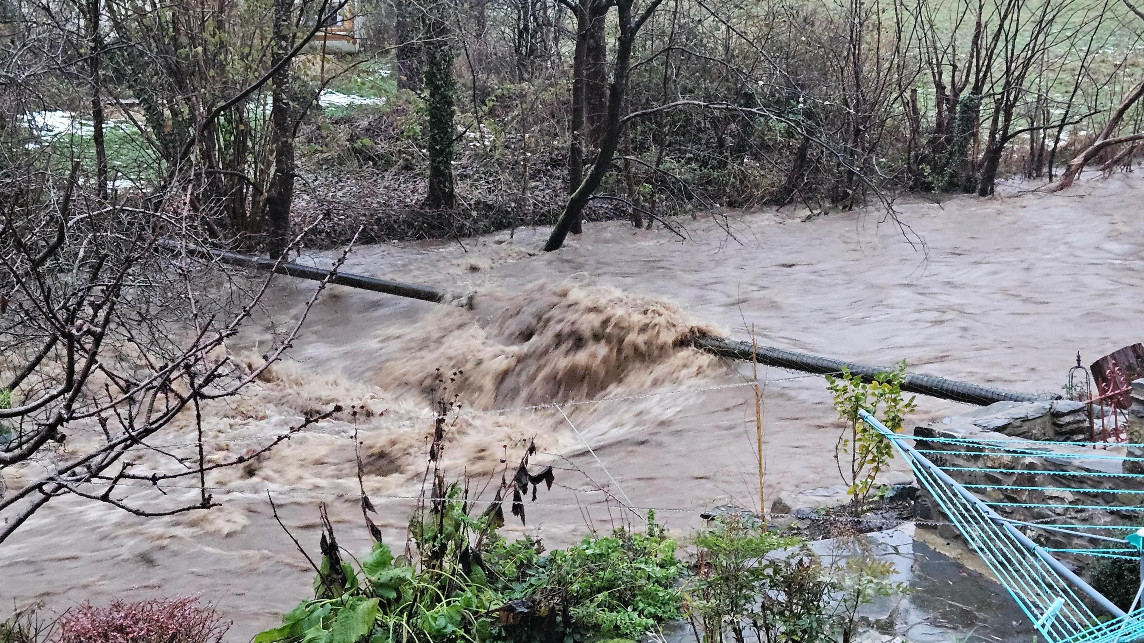 Torrential floodwater running from the River Ceiriog in north east Wales