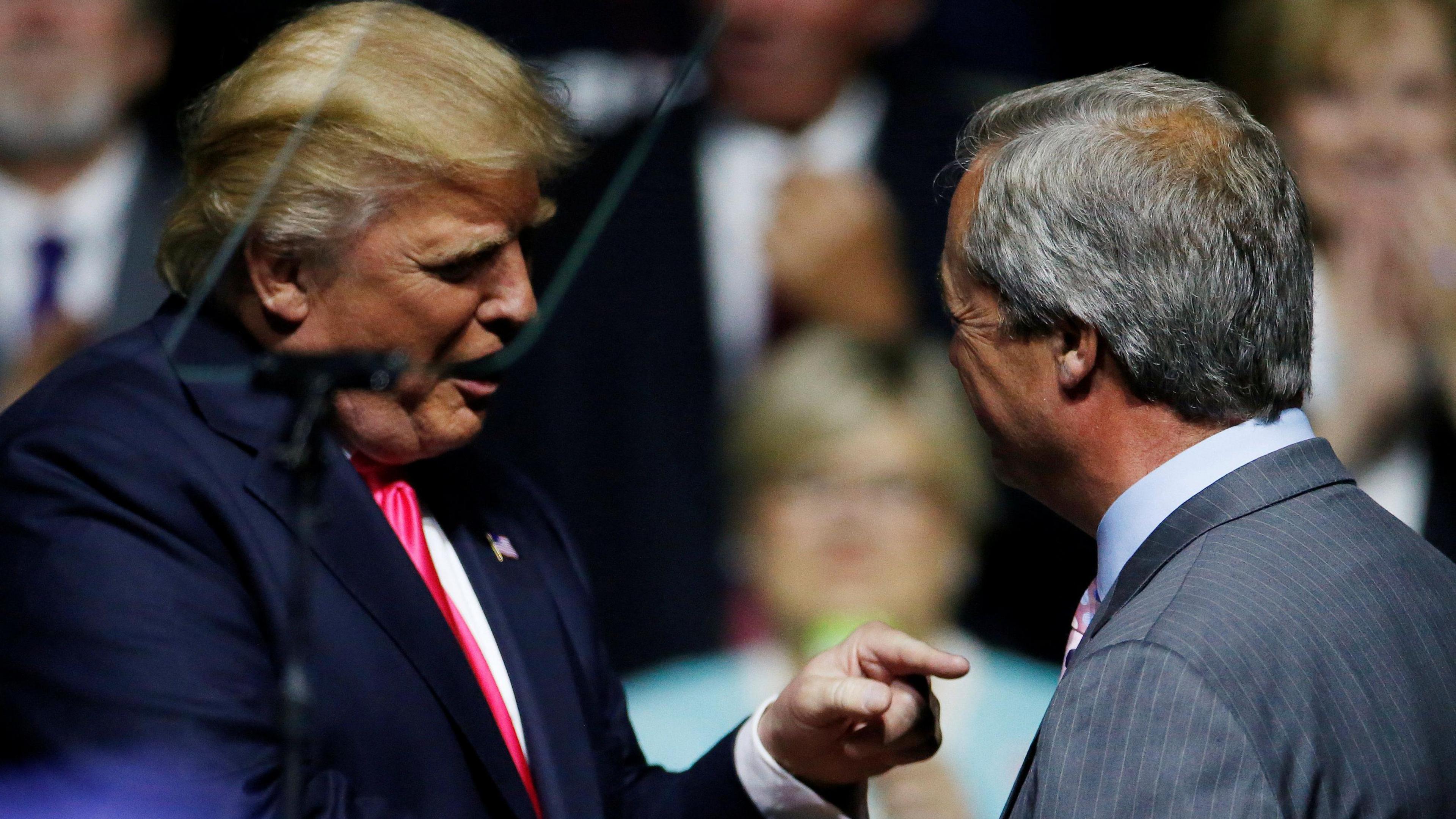 Donald Trump shaking hands with Nigel Farage at a rally in 2016