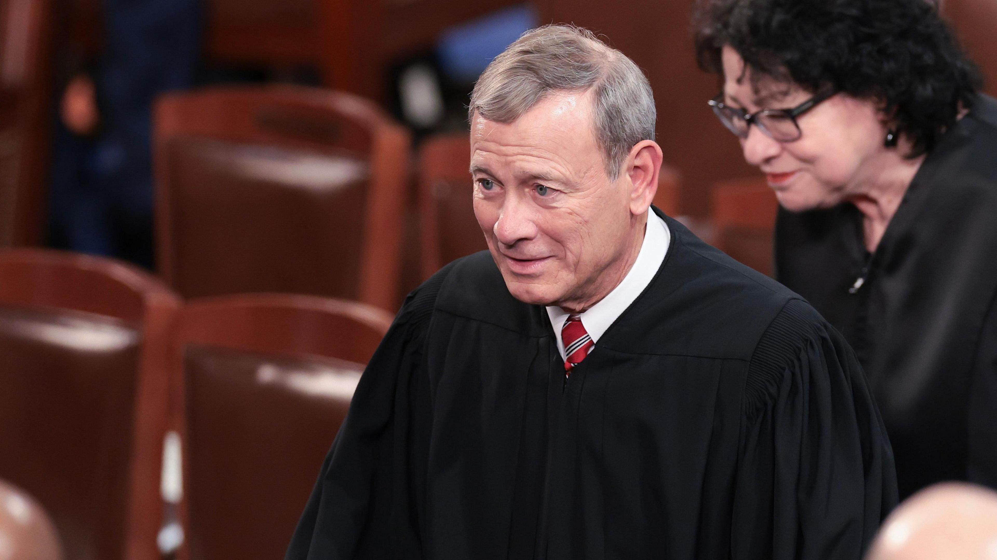 Supreme Court Chief Justice John Roberts' in a hall. 