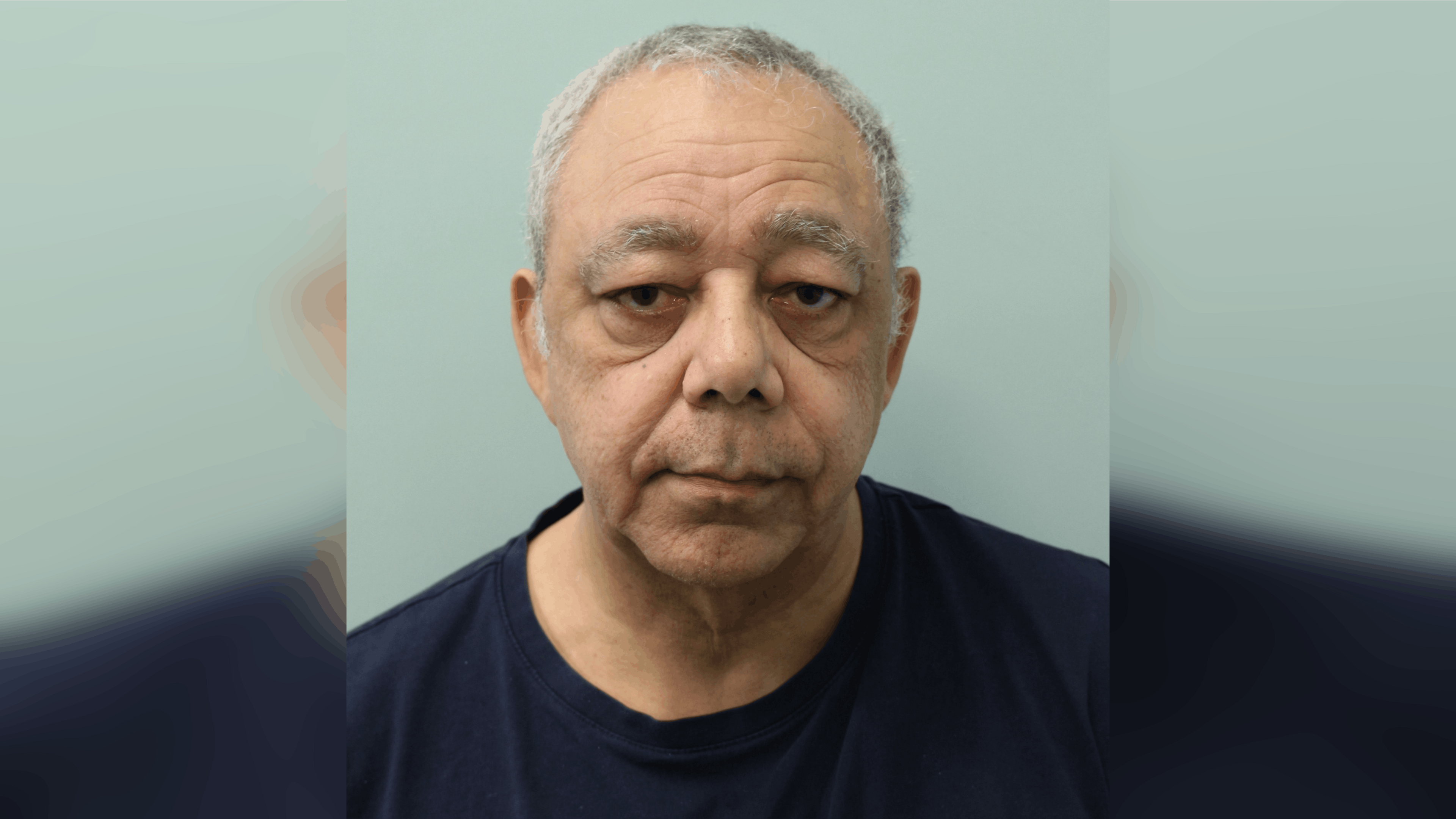 A custody image of Bradley Dilsworth wearing a black t-shirt. He has grey hair and is clean shaven.