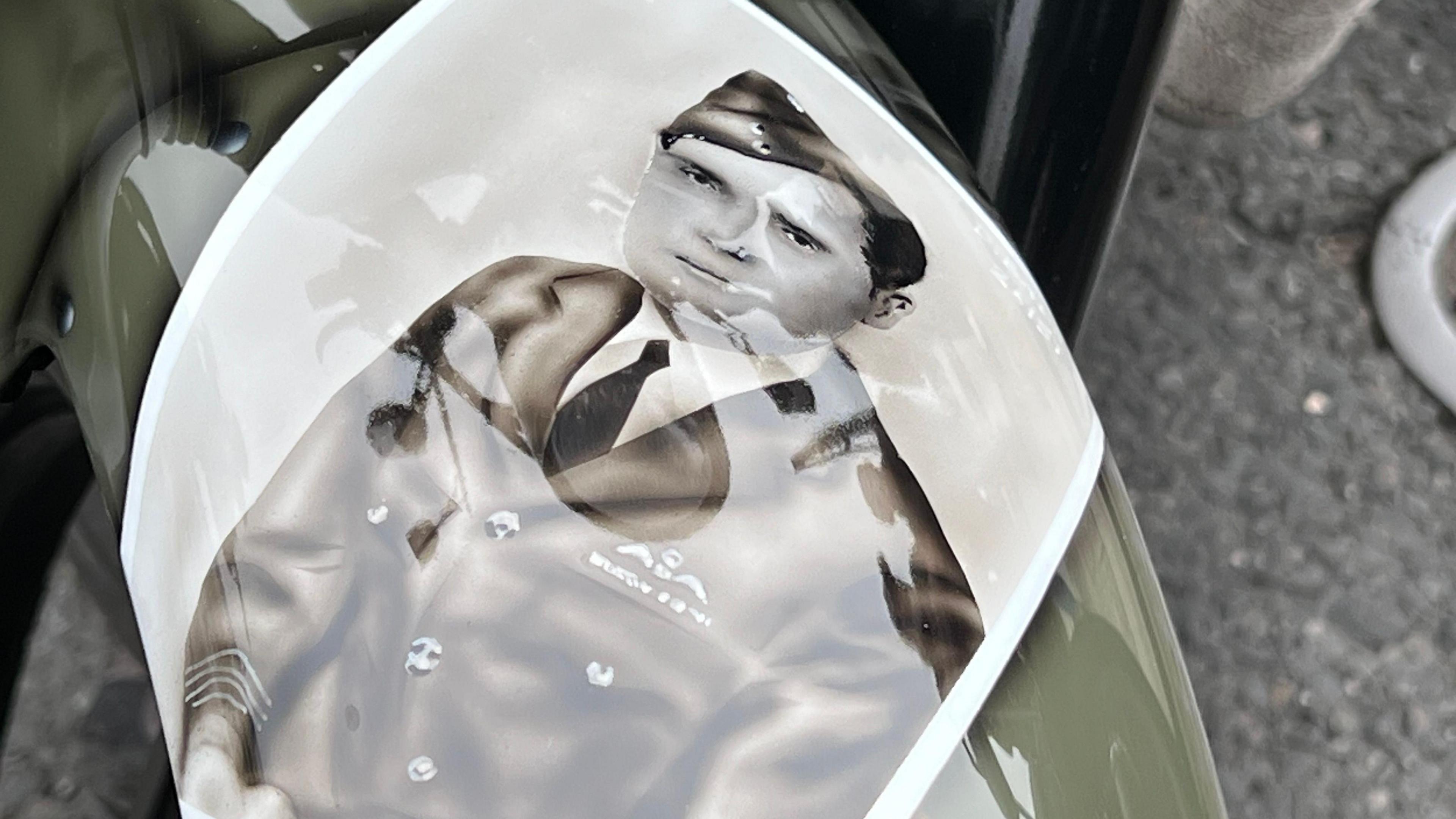 A spray painted image of a World War Two pilot on Mr Vincent's bike. The image is in black and white and shows the pilot in his army uniform.