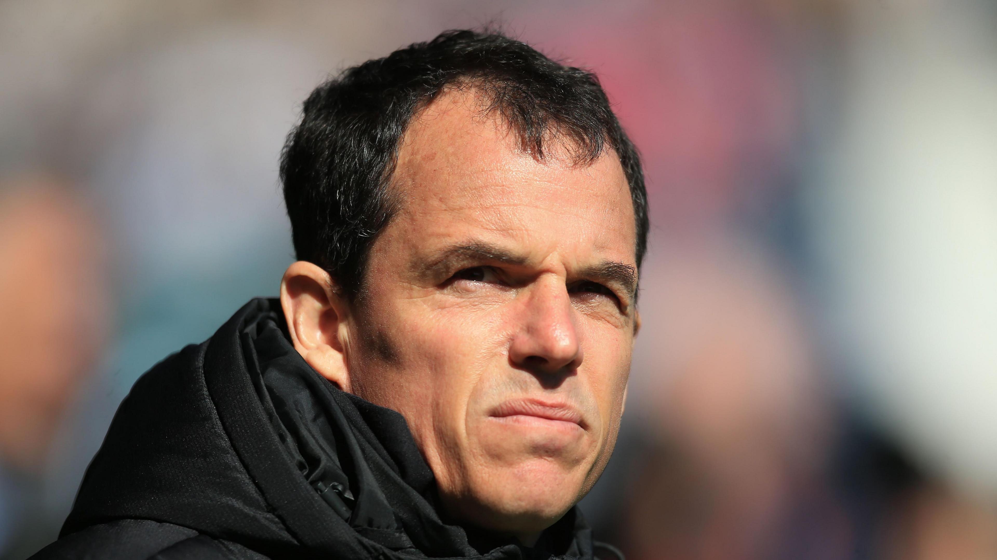 Sunderland head coach Regis Le Bris slightly squinting on a sunny afternoon