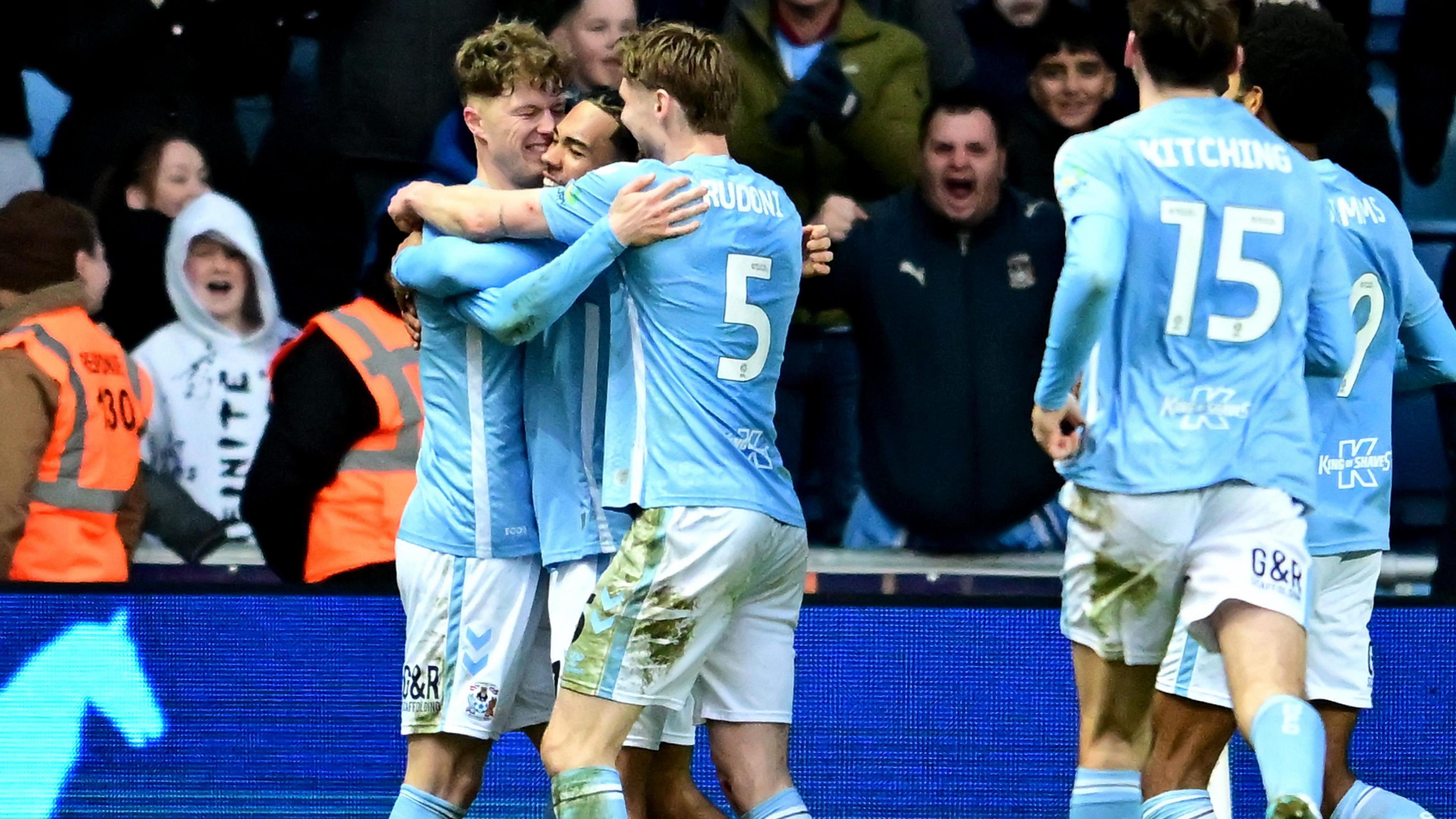 Coventry players celebrating with Victor Torp