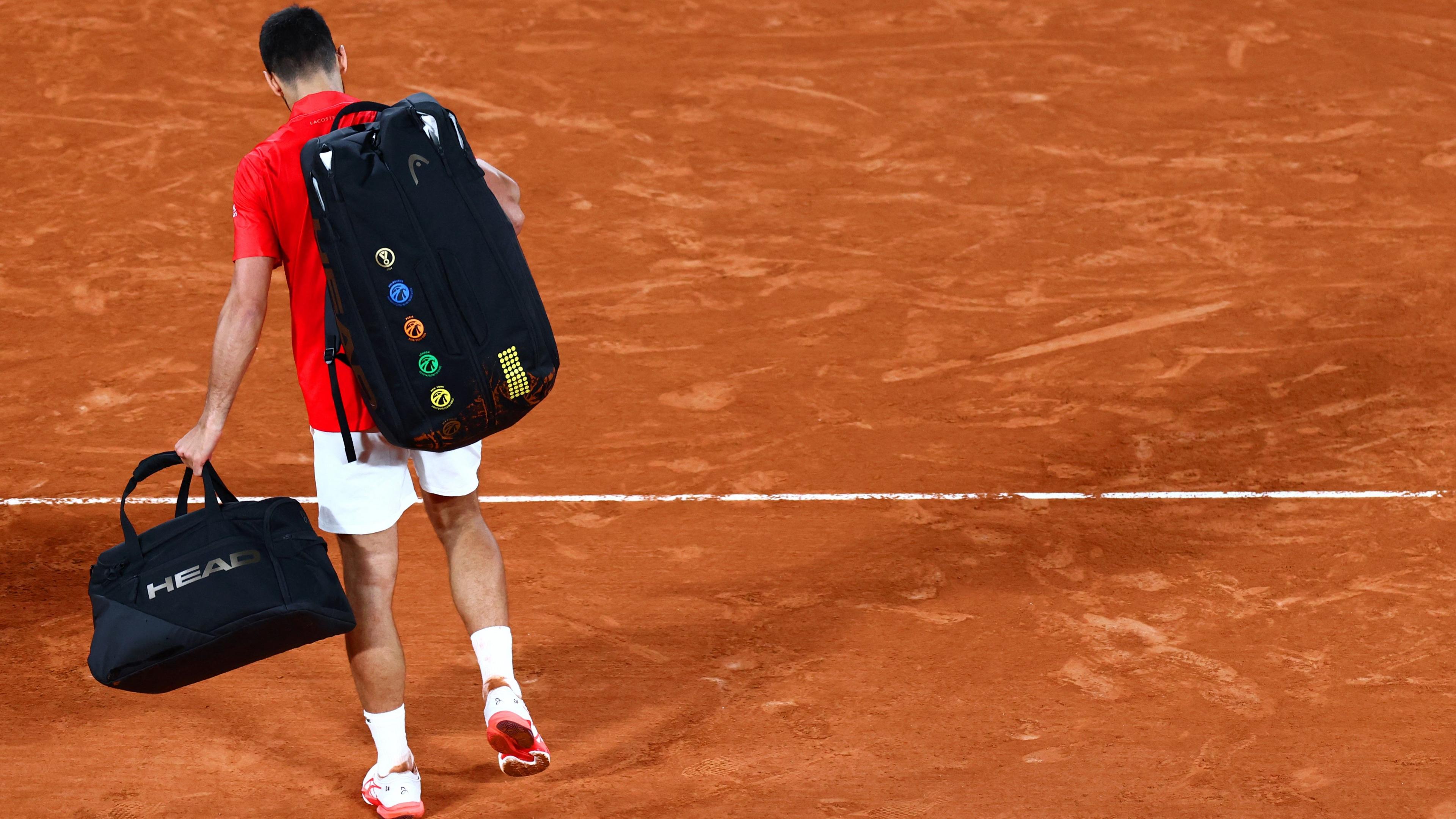 Novak Djokovic walks off Court Philippe Chatrier after his semi-final loss to Jannik Sinner