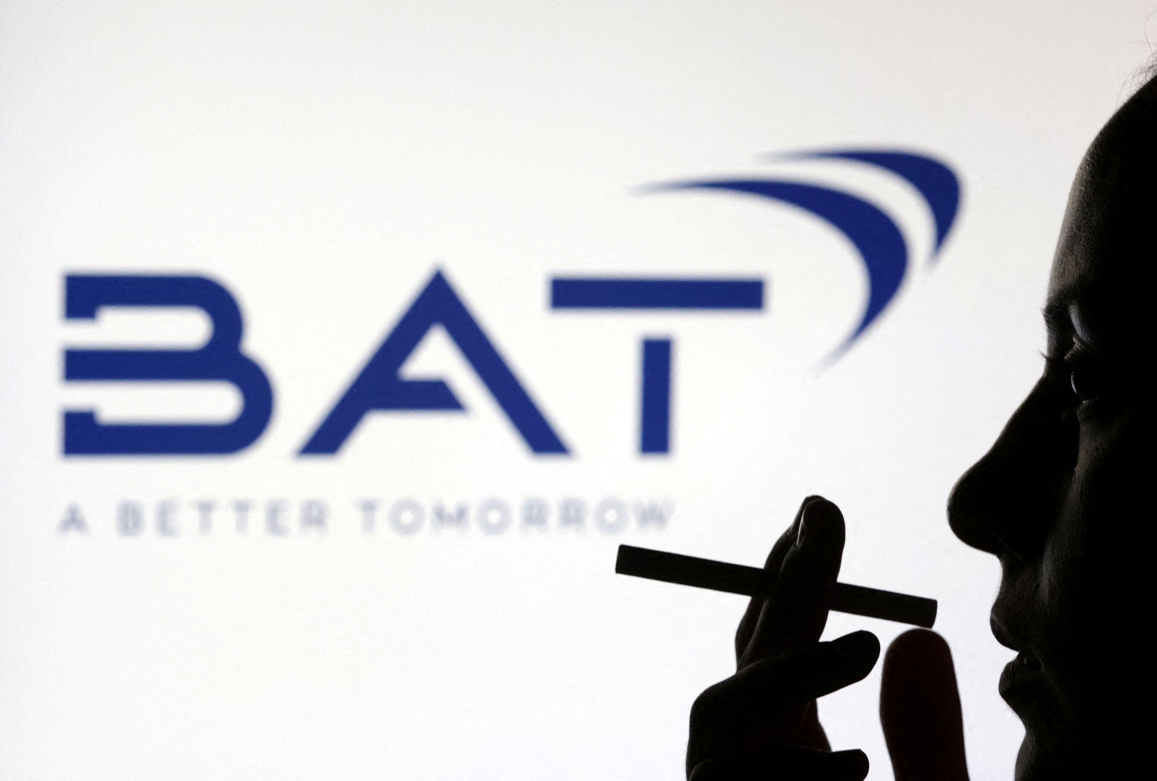 Silhouette of a person holding a cigarette in front of a dark blue BAT logo on a white background