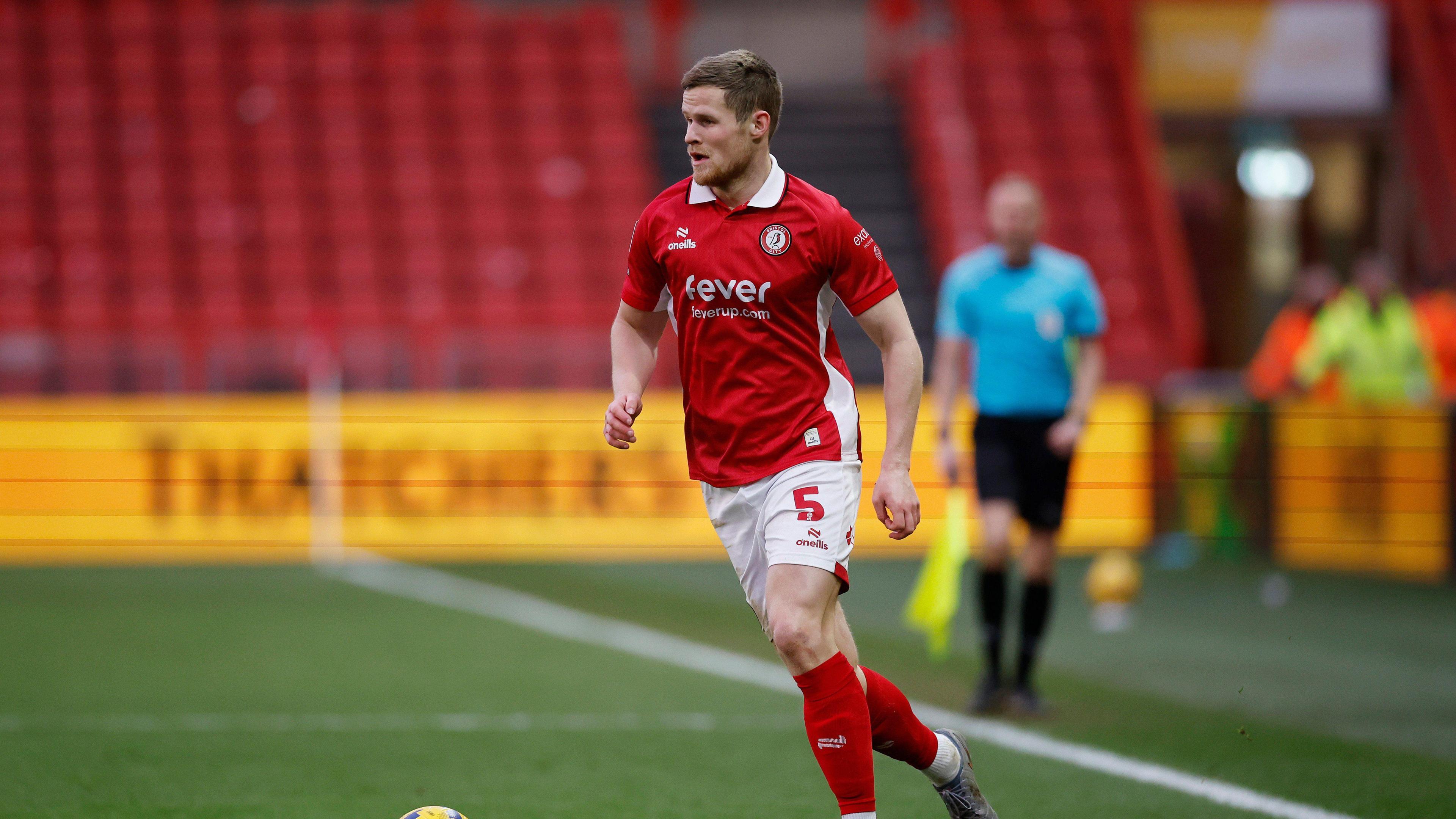 A photo of Rob Atkinson playing football in a Bristol City's home kit