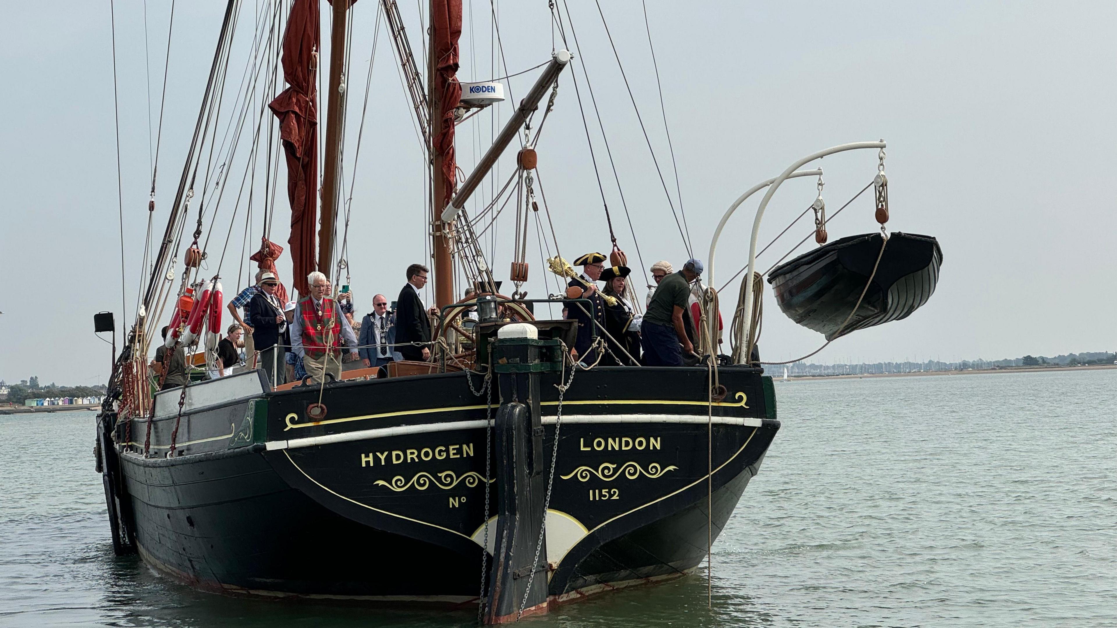 A barge with the words "Hydrogen London" at the front, with several people pictured on board