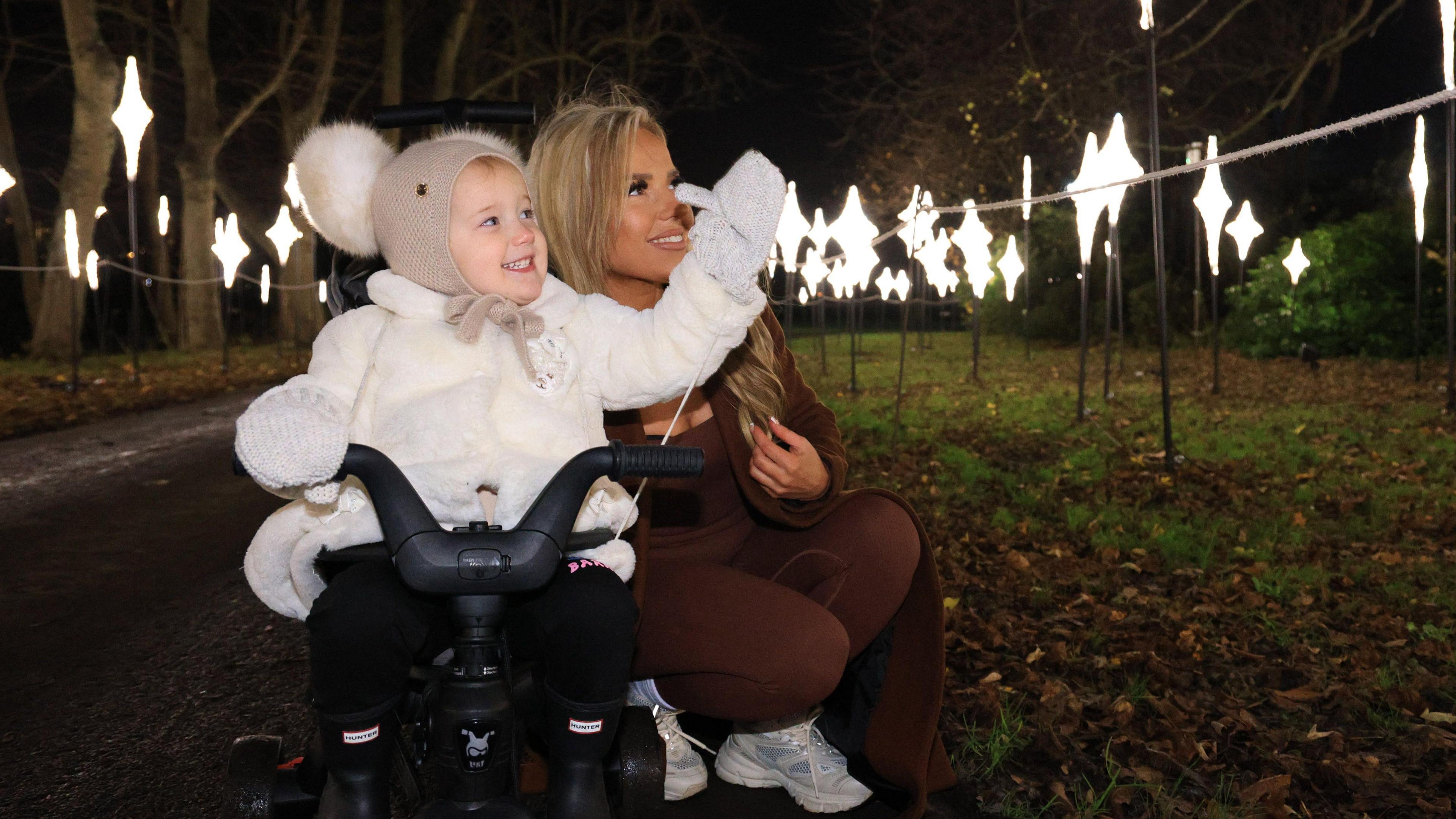 A mother and daughter enjoying the light trail