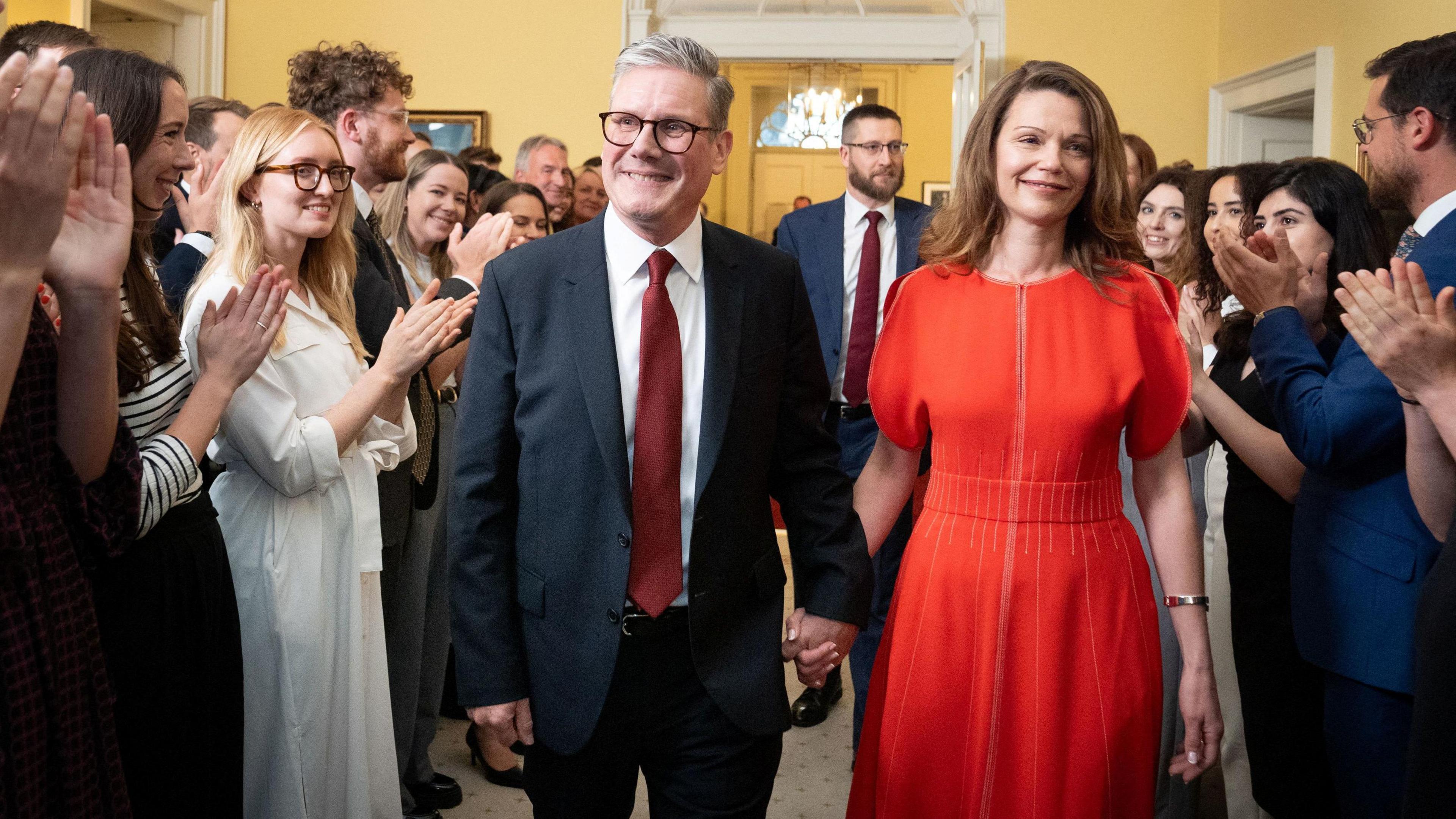 Sir Keir Starmer and his wife, Victoria, are clapped into Downing Street by staff