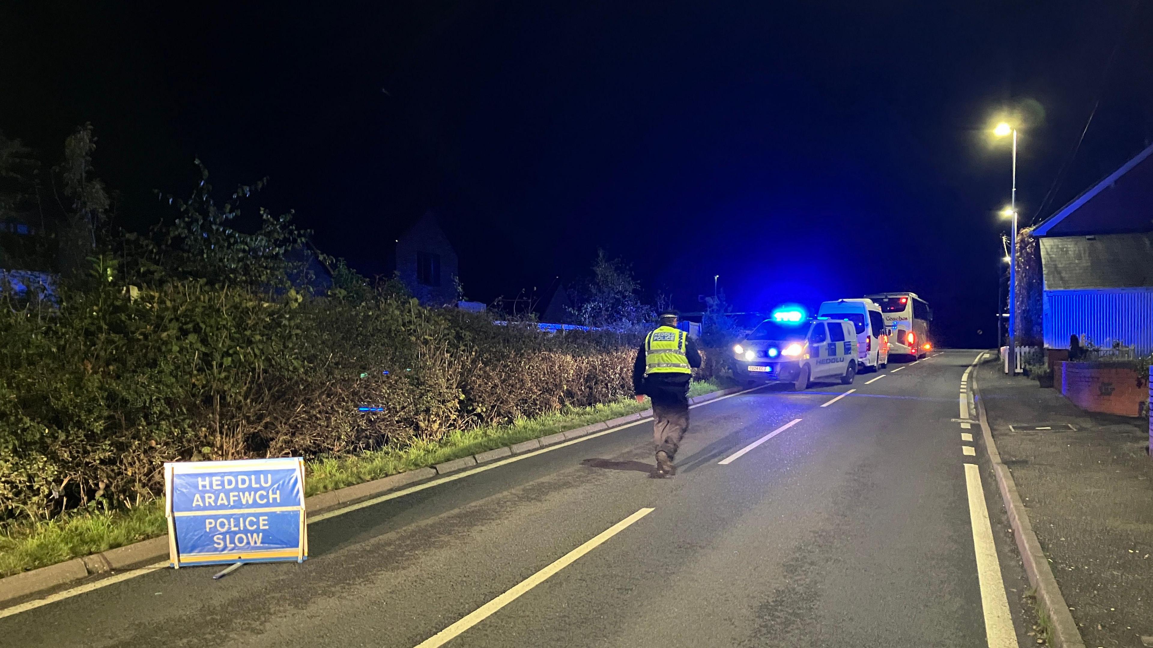 Police on the road after a rail crash was reported in Powys