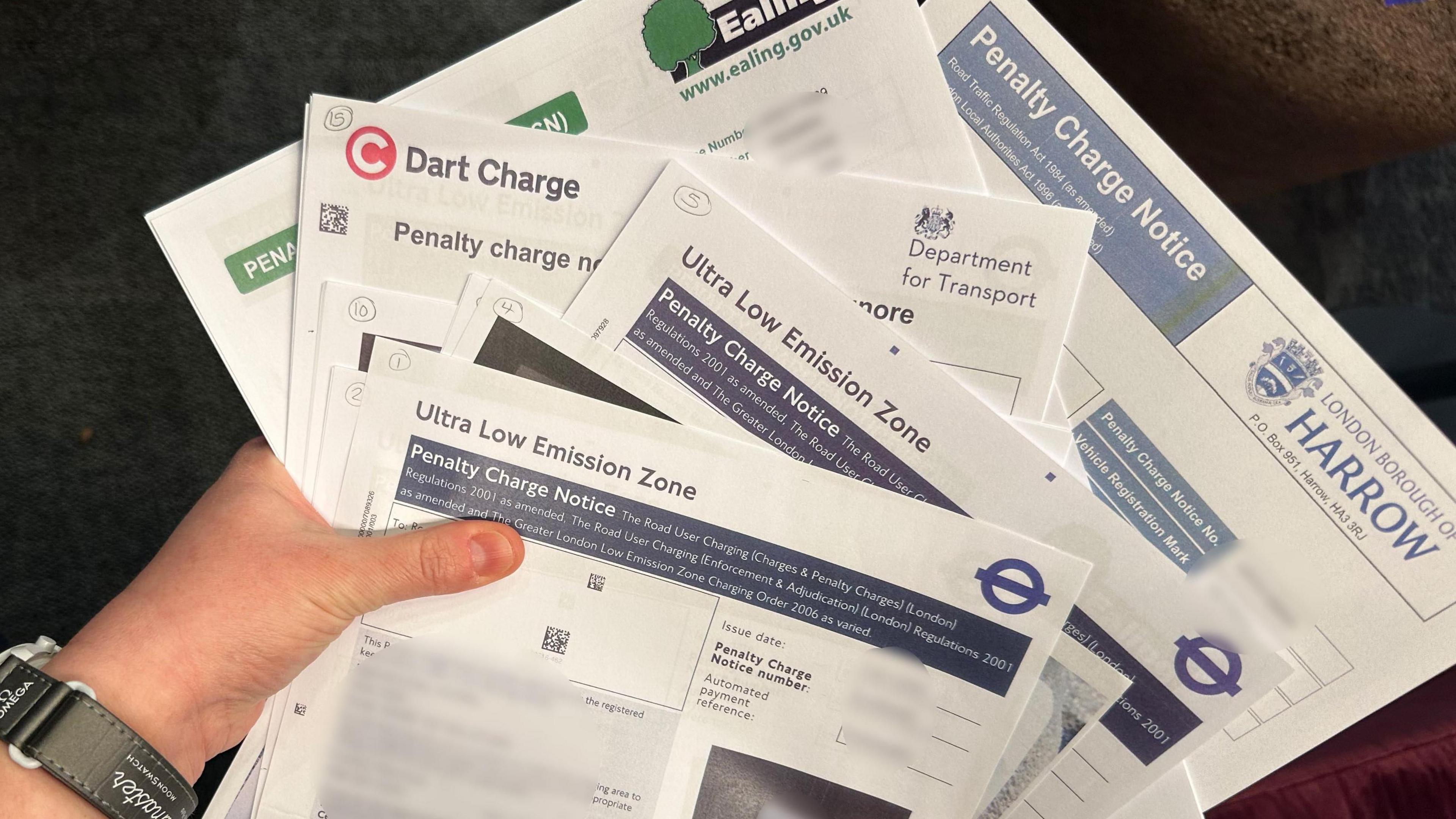 A range of printed letters about fines, held by Hilary Parker. Logos on them range from TfL to Dart Charge and Harrow Council Penalty Charge Notices