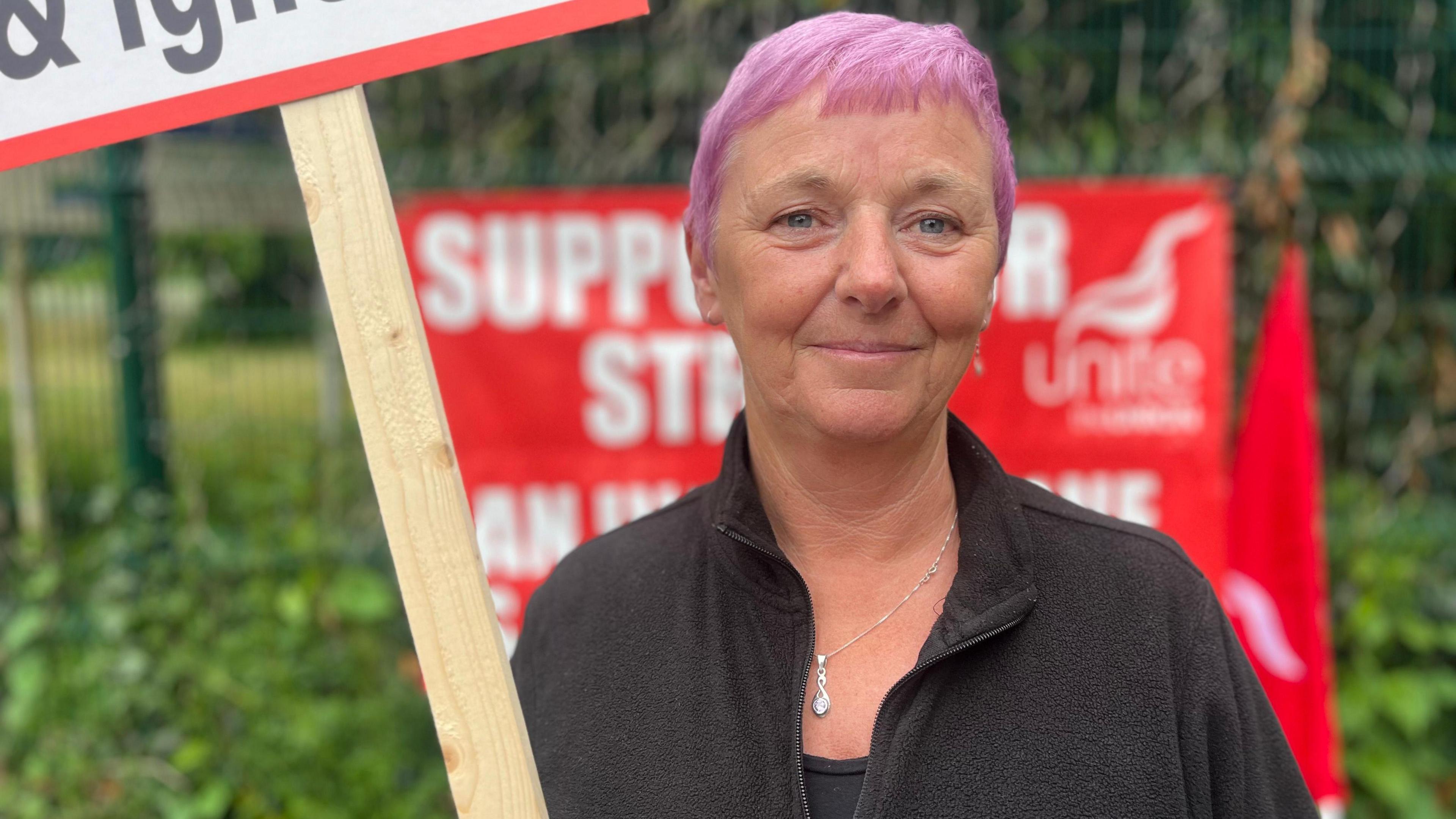 Geraldine Kelly holding a placard