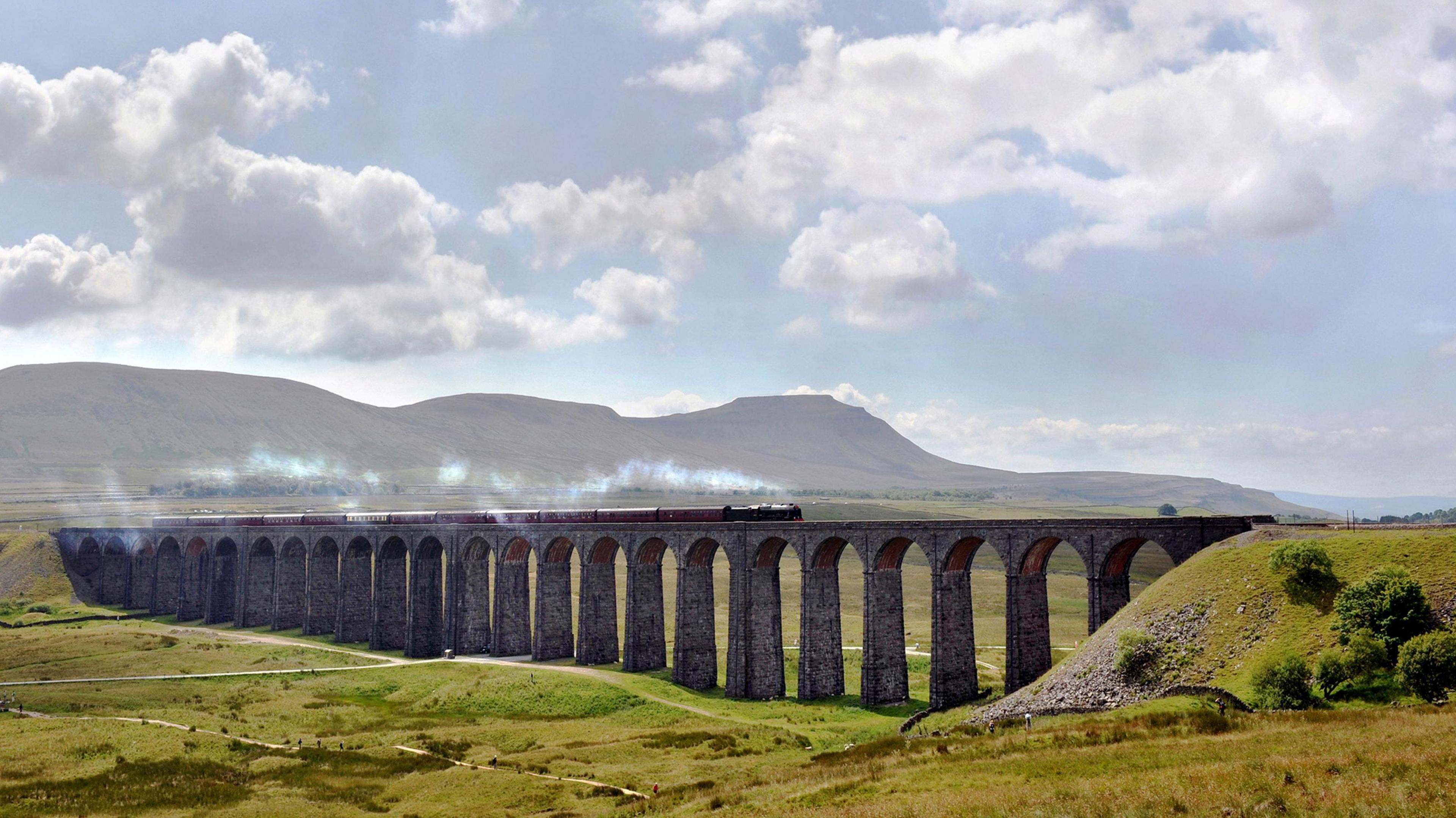 A vintage steam train passes over the Ribblehead viaduct in North Yorkshire