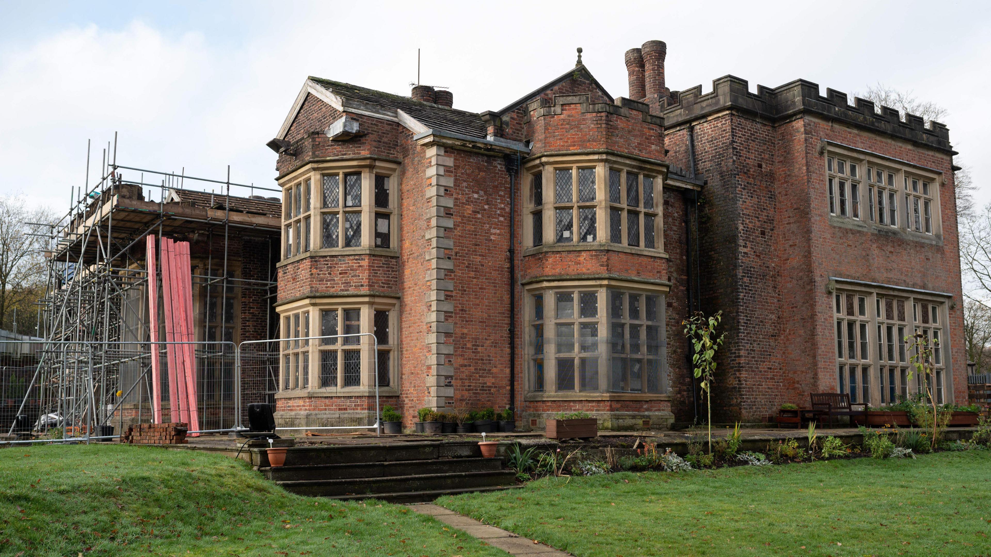 Exterior of Hopwood Hall with scaffolding on one side, pictured in 2022