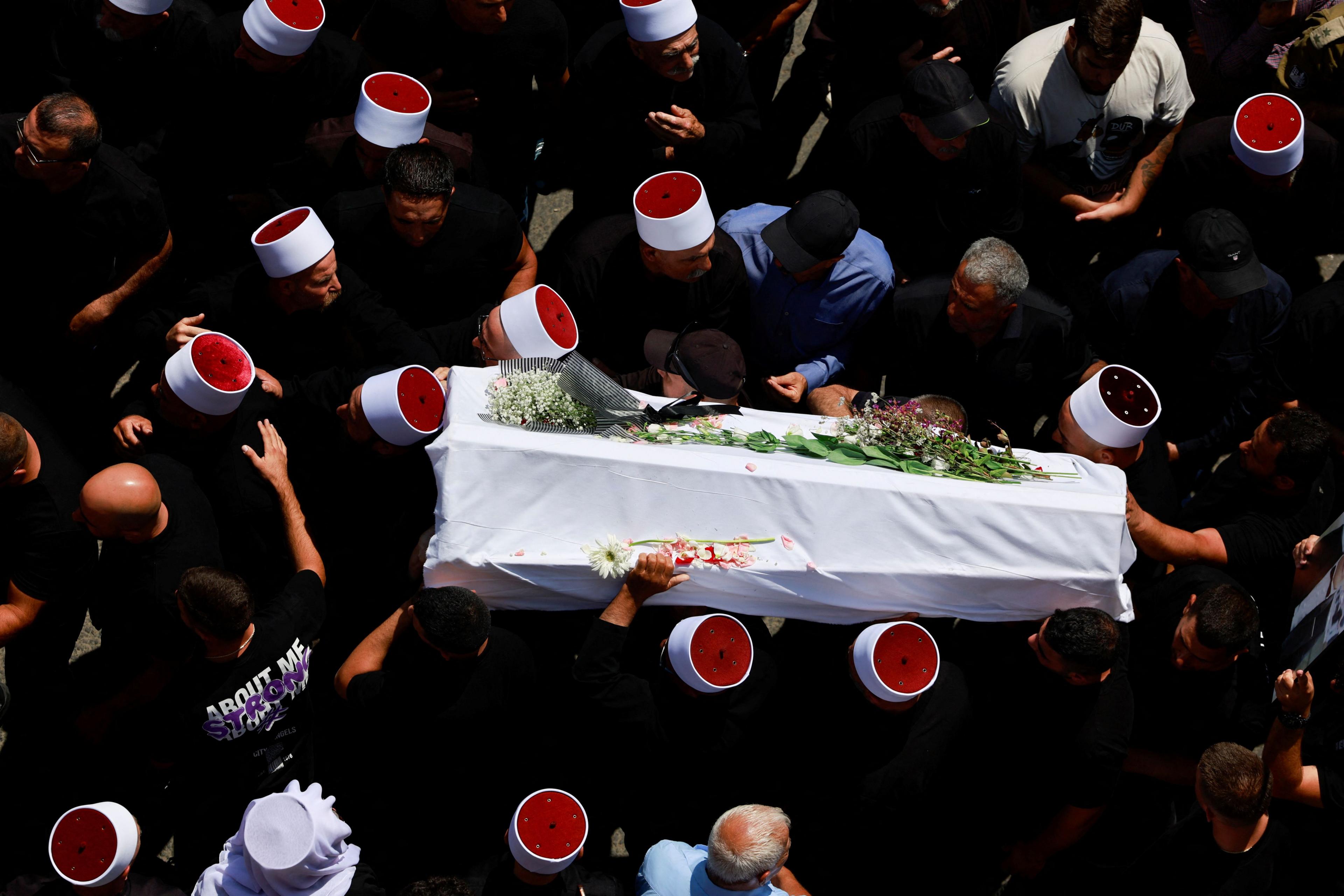 Mourners carry a child's coffin