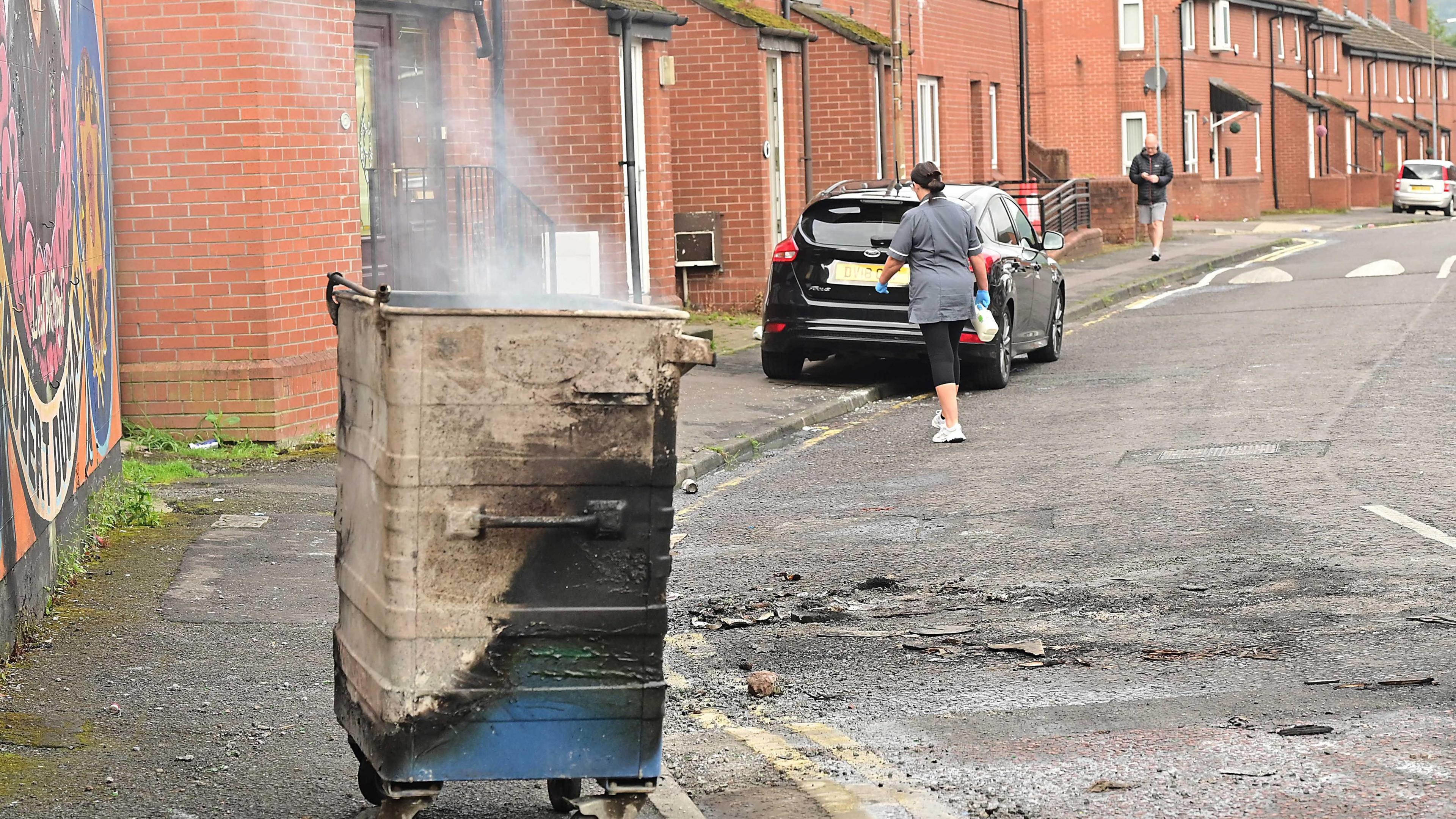 A smoking bin remains in the daylight of Tuesday 