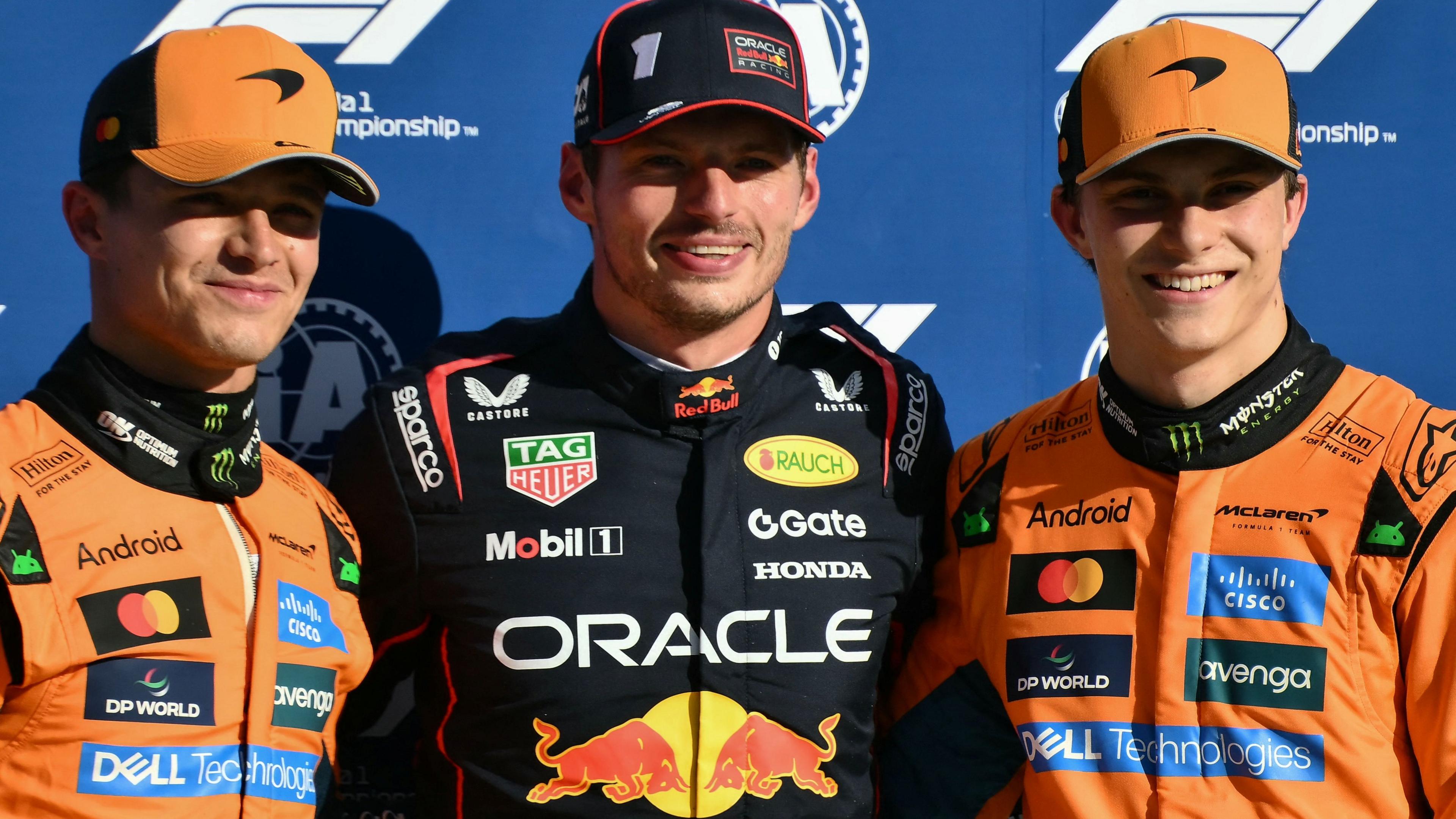 McLaren's Lando Norris, Red Bull's Max Verstappen and McLaren's Oscar Piastri stand together after qualifying in the top three for the 2025 Italian Grand Prix