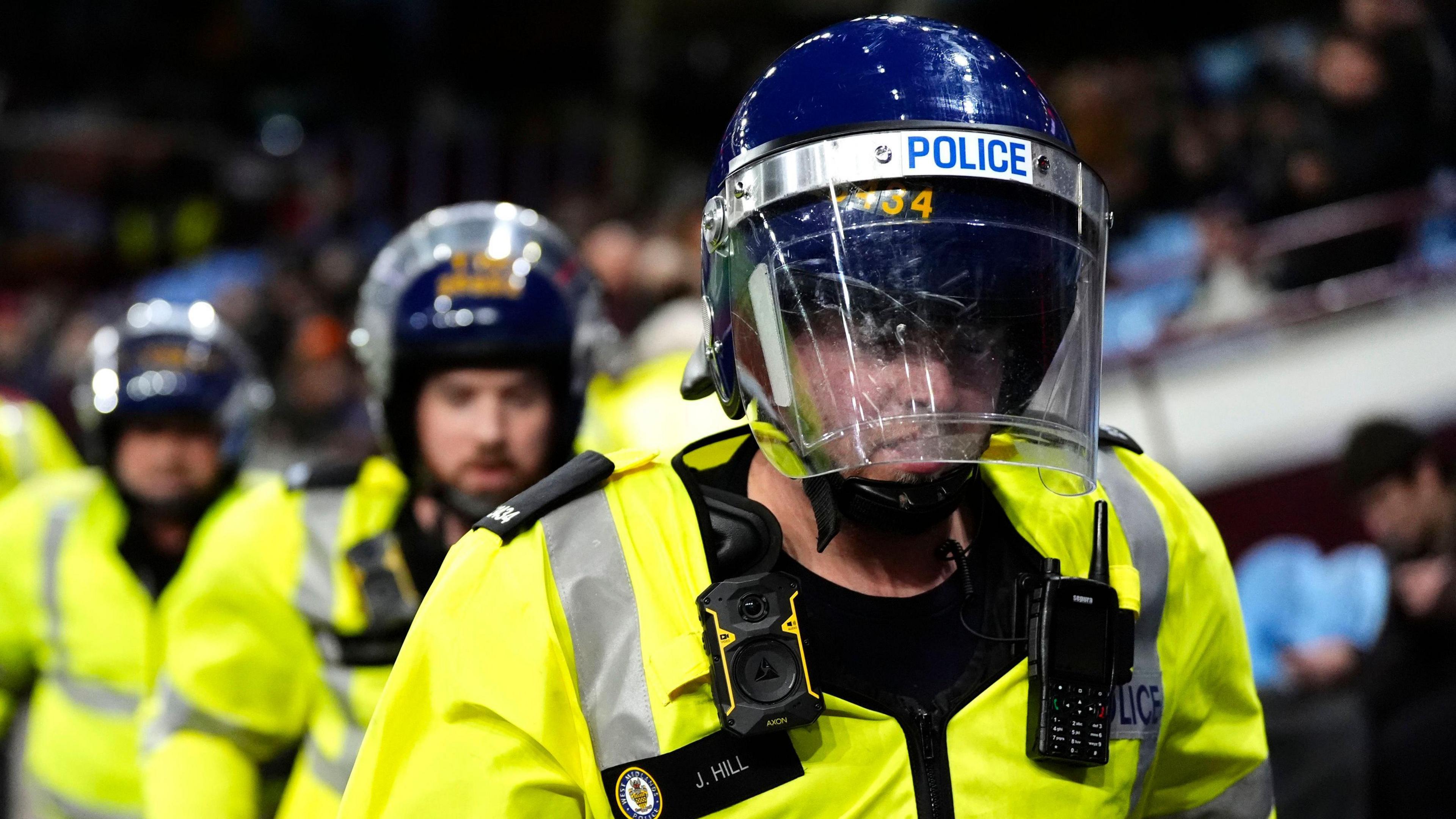 Police with hi-vis jackets on and protective head gear on during the UEFA Europa League, league phase match at Villa Park, Birmingham