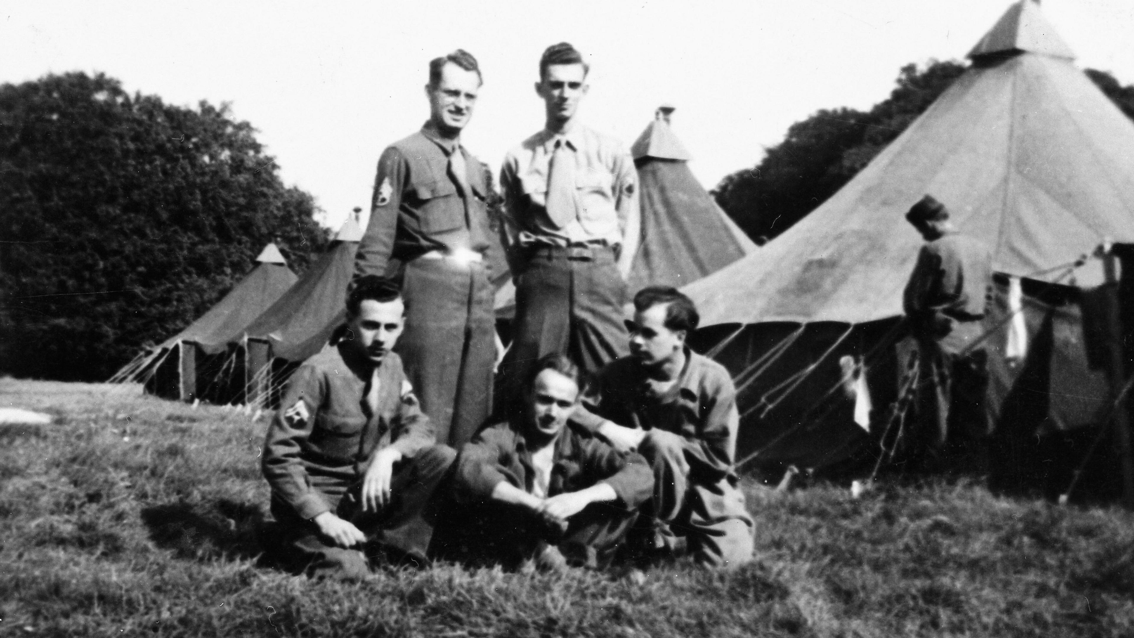 A black and white photograph of US Army soldiers - likely to be 101st Airborne Division - with Lydiard Park Camp tents in the background.