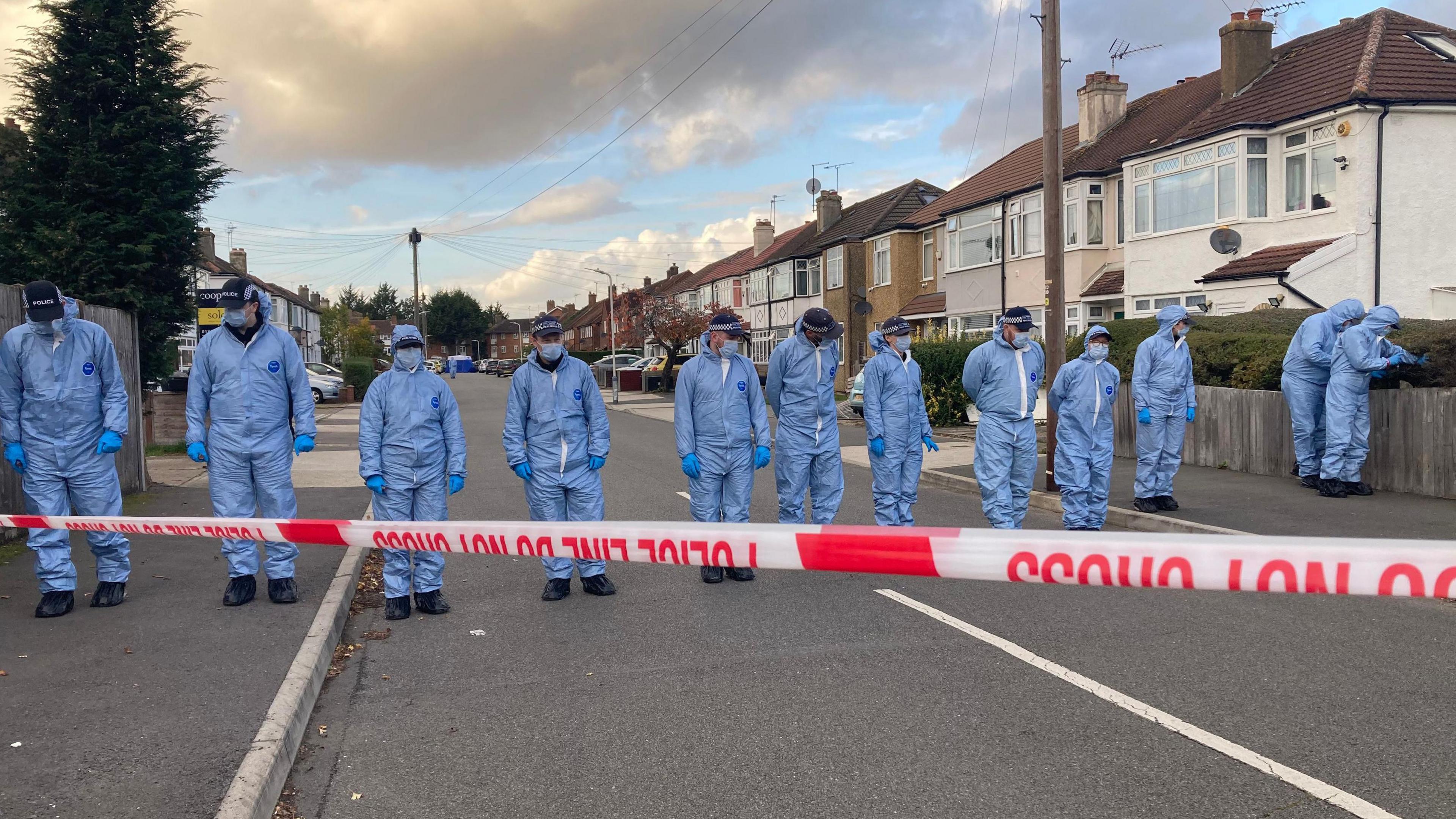 Forensic officers at the scene in Midhurst Gardens in Uxbridge.
