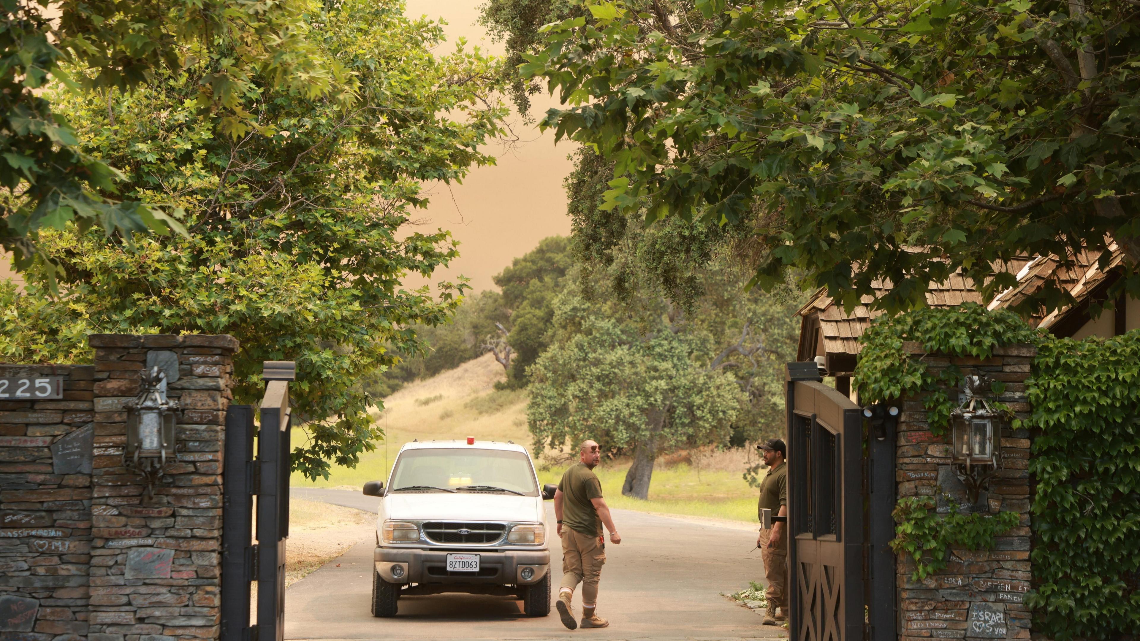 Smoke from the Lake Fire fills the air as it burns near to the entrance of Michael Jackson's former Neverland Ranch in Los Olivos, California on 6 July.