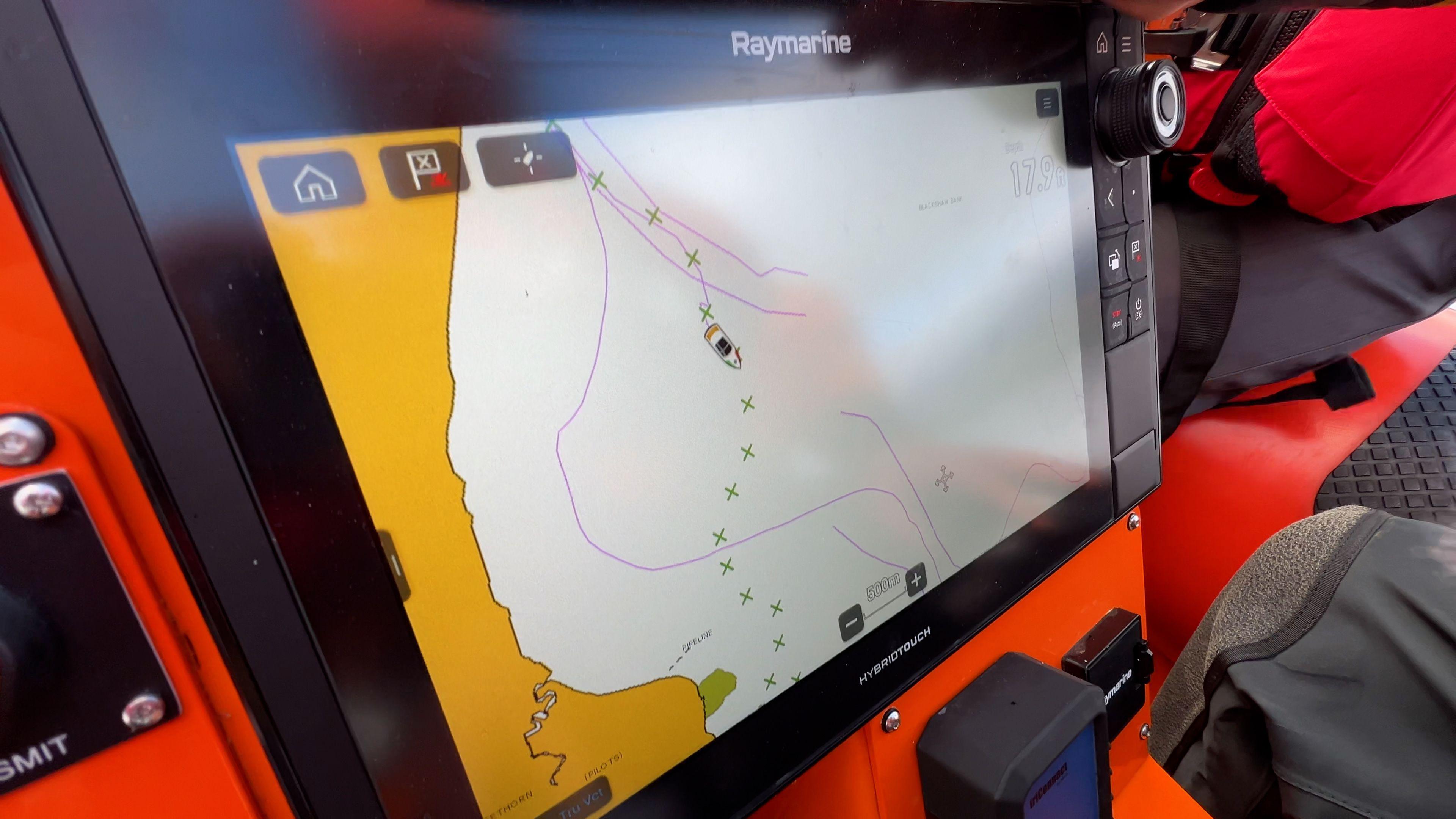 A computer screen shows a map of a safe route for a boat through the mudflats of the Solway